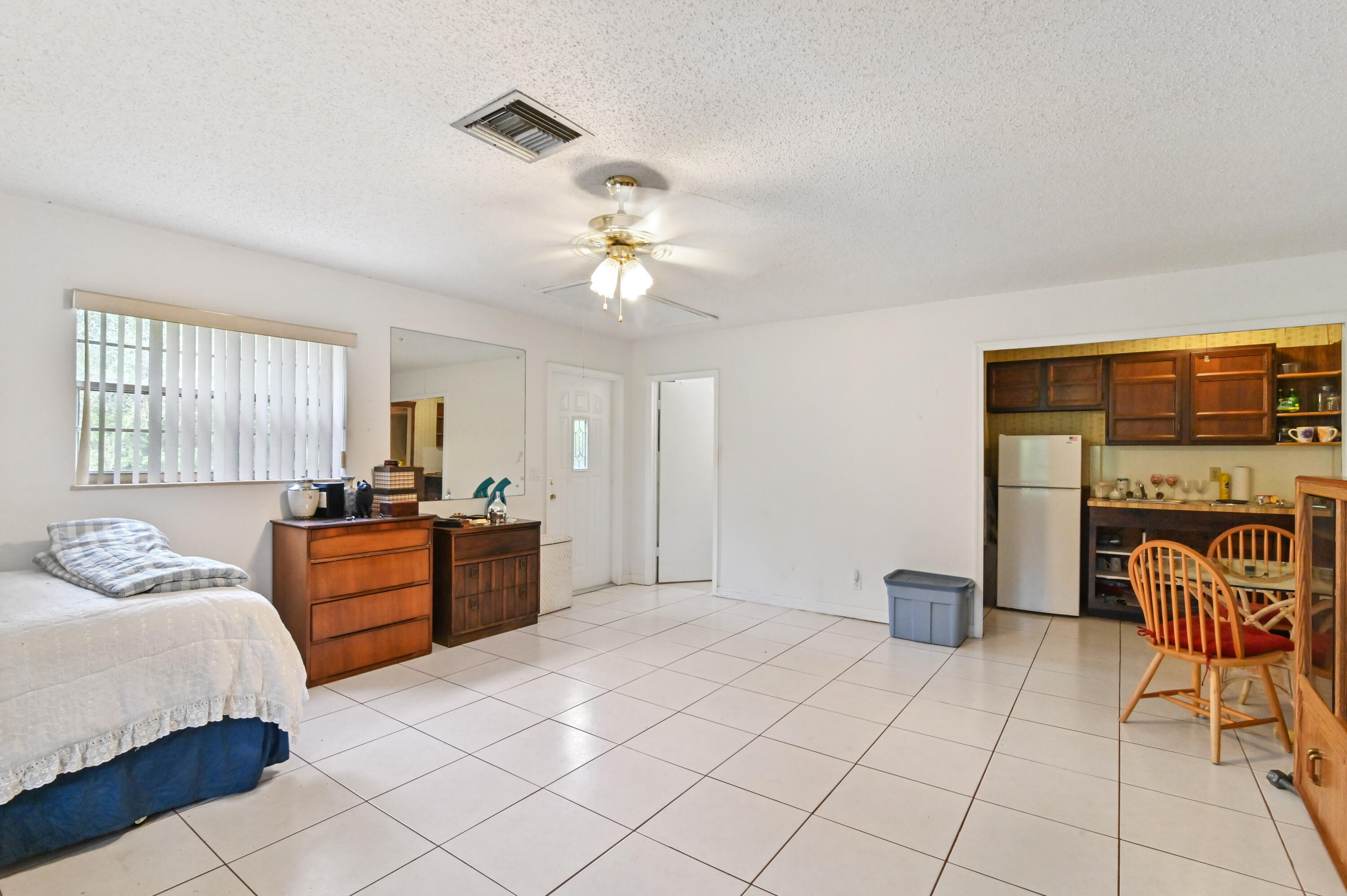 3208 A Road Loxahatchee Groves, FL 33470 - Photo 31 of 51 a bedroom with a bed and a chandelier