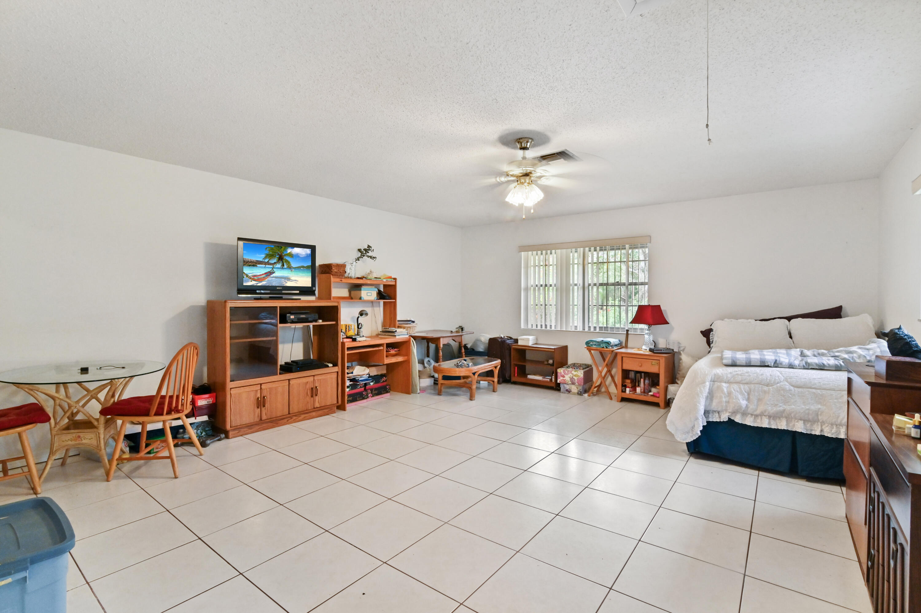 3208 A Road Loxahatchee Groves, FL 33470 - Photo 32 of 51 a living room with furniture and a flat screen tv