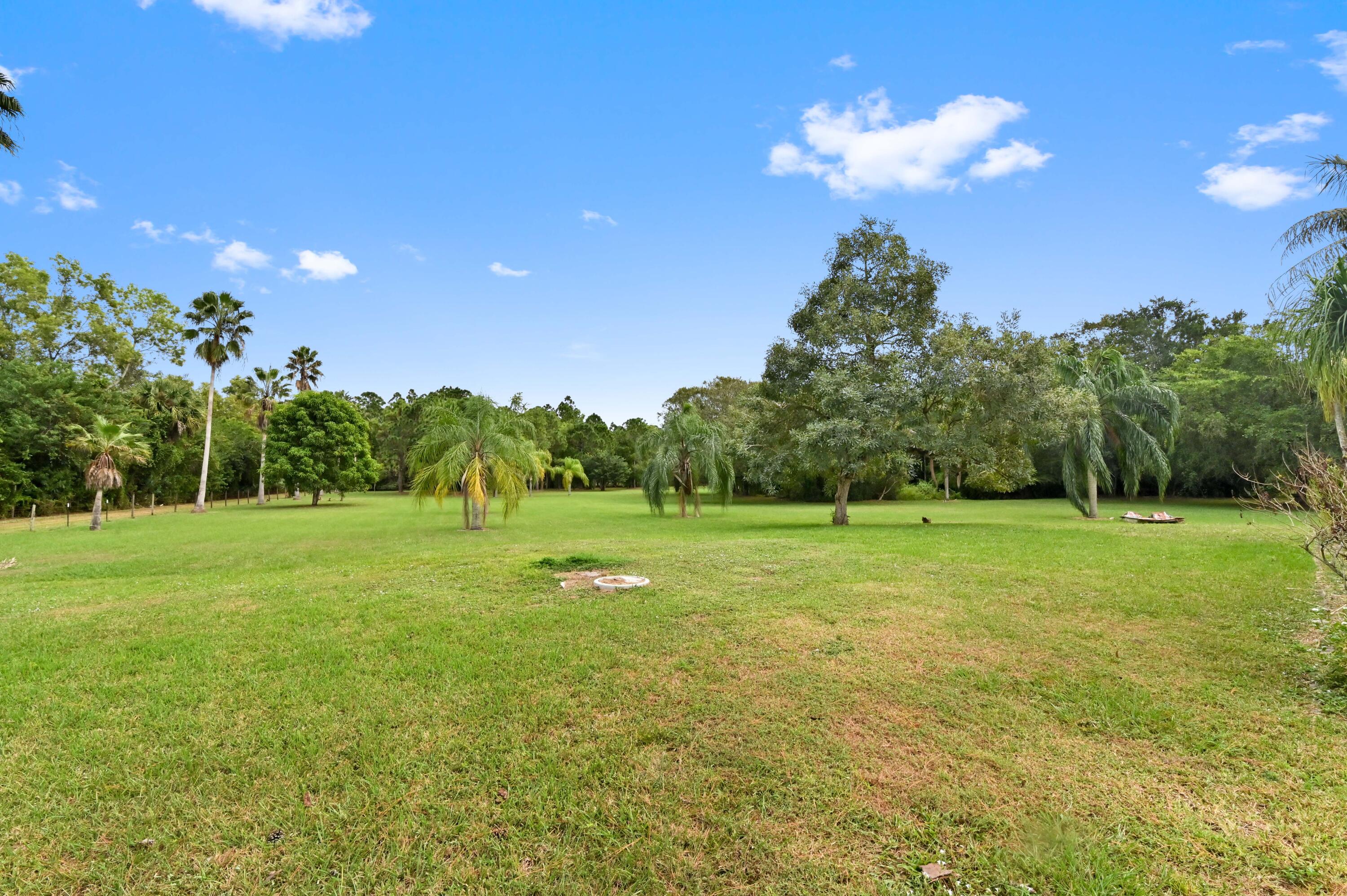 3208 A Road Loxahatchee Groves, FL 33470 - Photo 35 of 51 a view of field with trees in the background