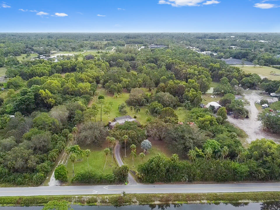 3208 A Road Loxahatchee Groves, FL 33470 - Photo 40 of 51 an aerial view of residential houses with outdoor space and trees