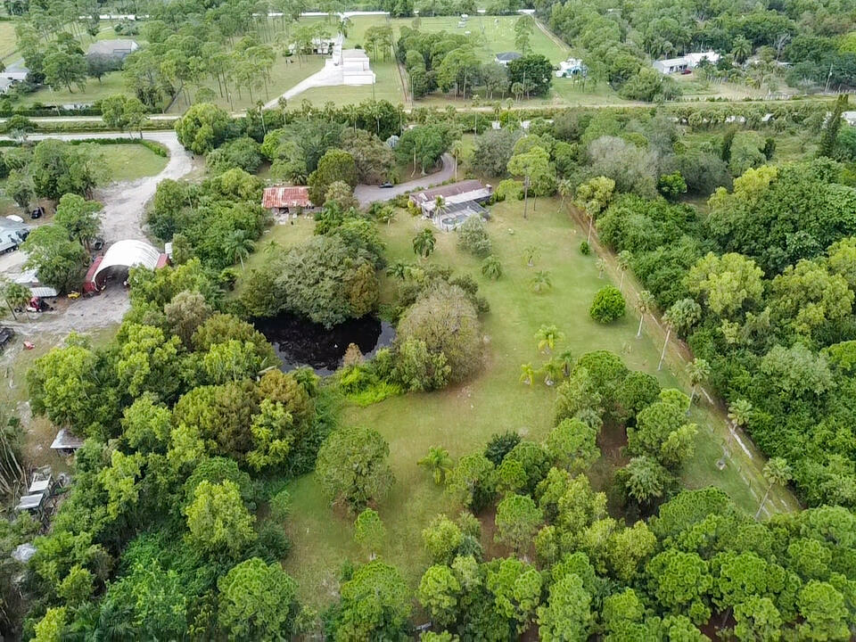 3208 A Road Loxahatchee Groves, FL 33470 - Photo 42 of 51 an aerial view of residential house with outdoor space and trees all around