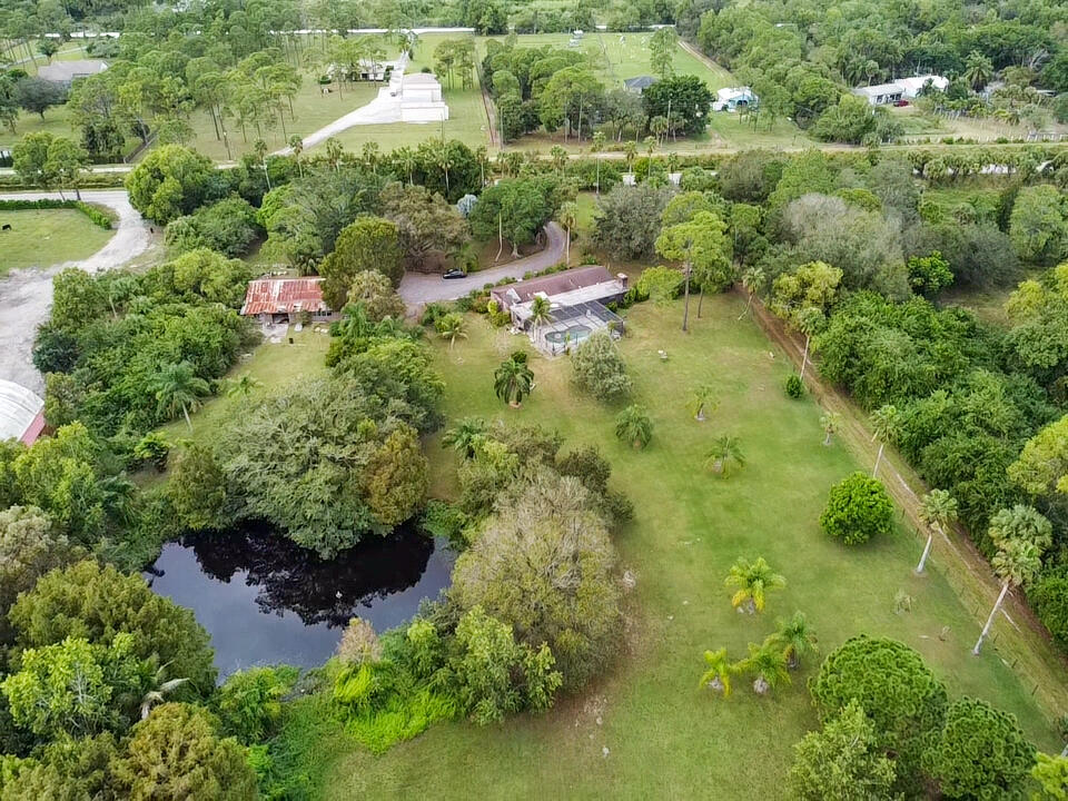 3208 A Road Loxahatchee Groves, FL 33470 - Photo 43 of 51 an aerial view of residential house with outdoor space and trees all around
