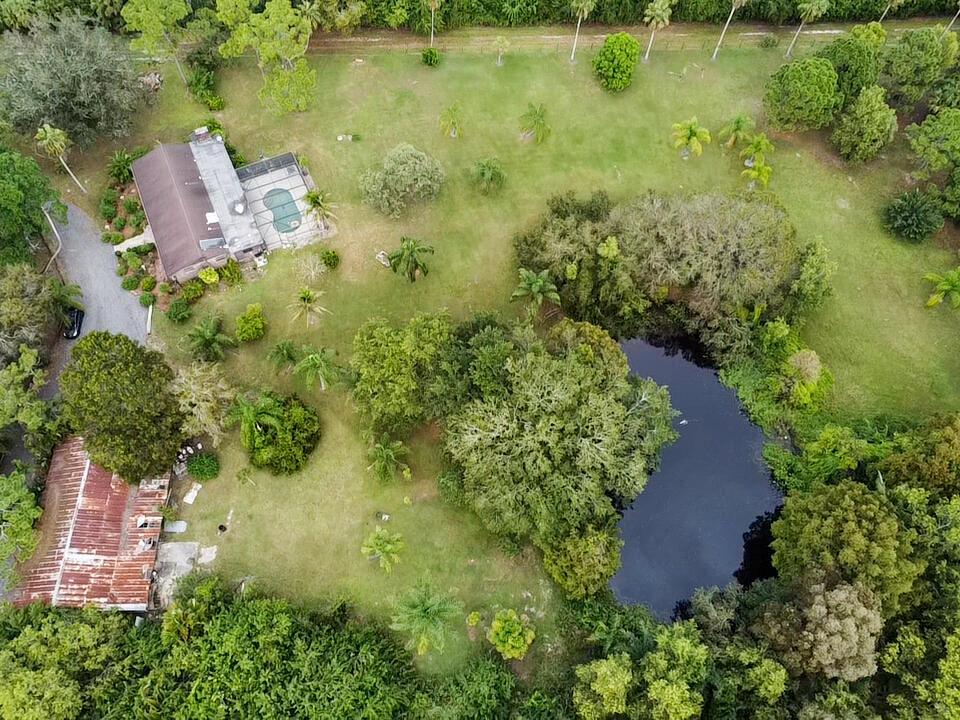 3208 A Road Loxahatchee Groves, FL 33470 - Photo 44 of 51 an aerial view of residential houses with outdoor space and trees all around