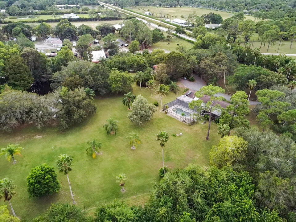 3208 A Road Loxahatchee Groves, FL 33470 - Photo 45 of 51 a view of a lake with a yard