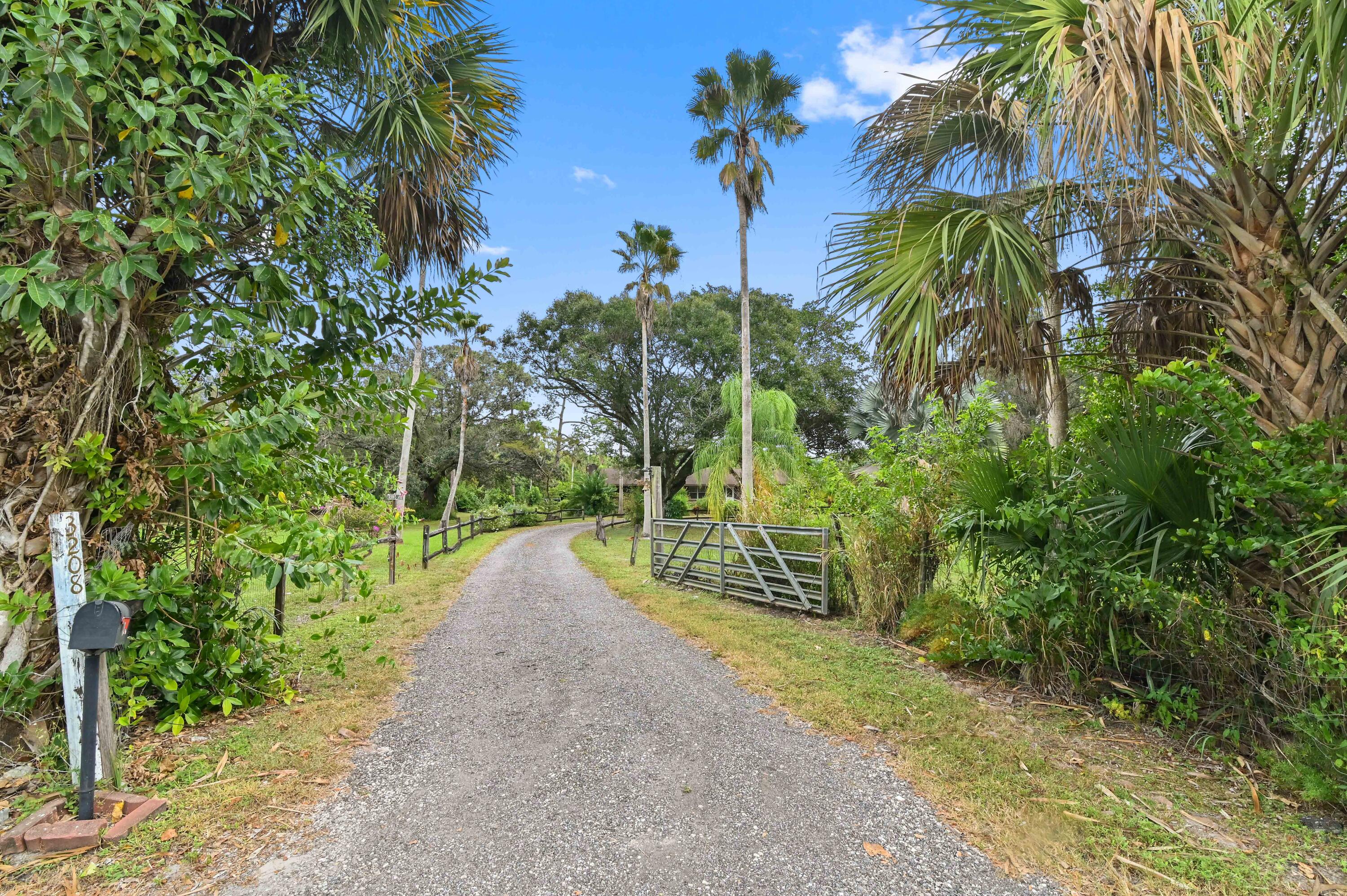 3208 A Road Loxahatchee Groves, FL 33470 - Photo 48 of 51 a view of a street with a tree