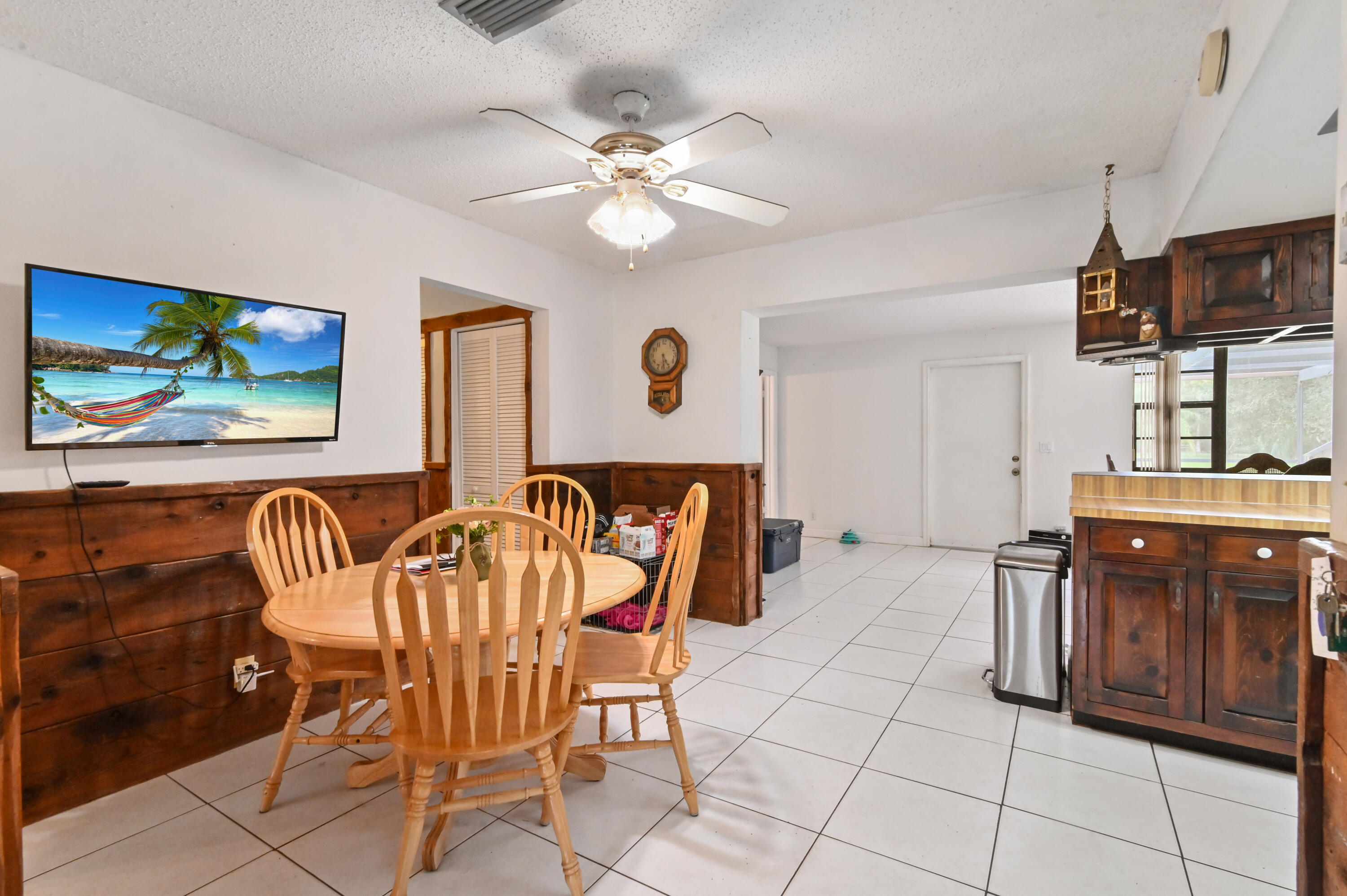 3208 A Road Loxahatchee Groves, FL 33470 - Photo 10 of 51 a view of a dining room with furniture and chandelier