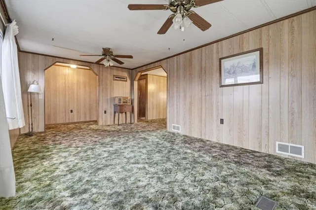 a view of kitchen with granite countertop cabinets and window
