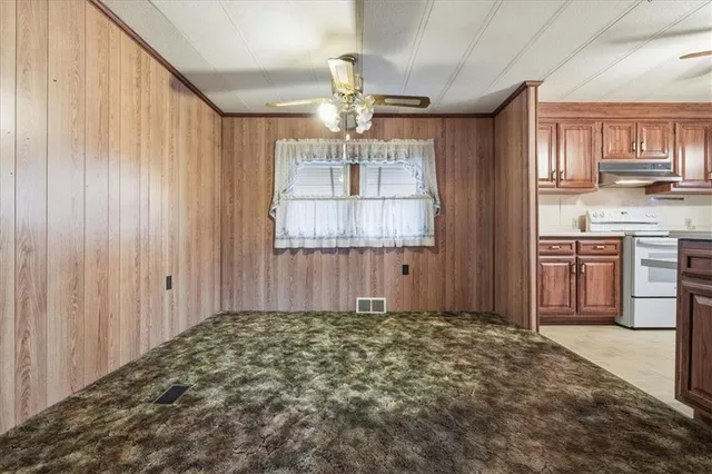 a view of a hallway to rooms and wooden floor