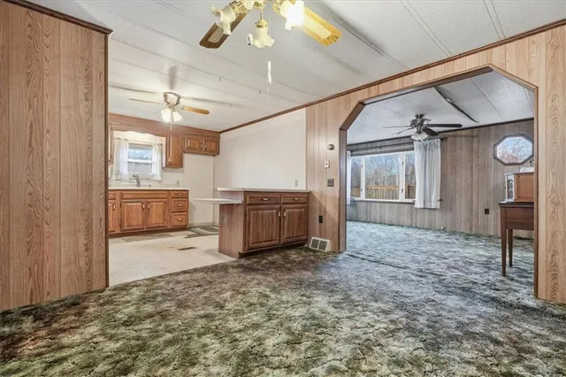 a kitchen with a stove a sink and cabinets