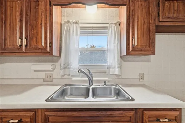 a kitchen with a stove cabinets and window