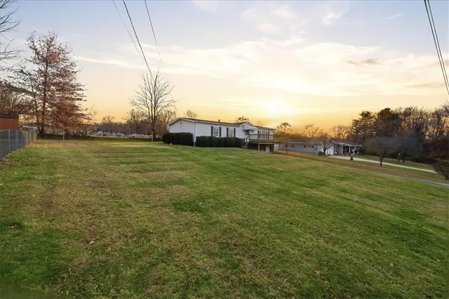 a view of a field with trees in the background
