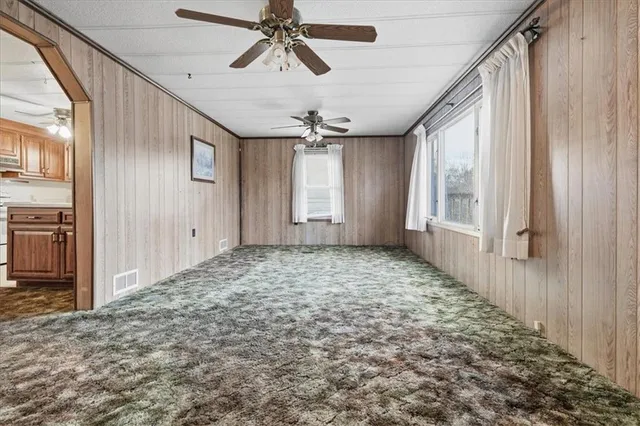 a view of a livingroom with a window and furniture