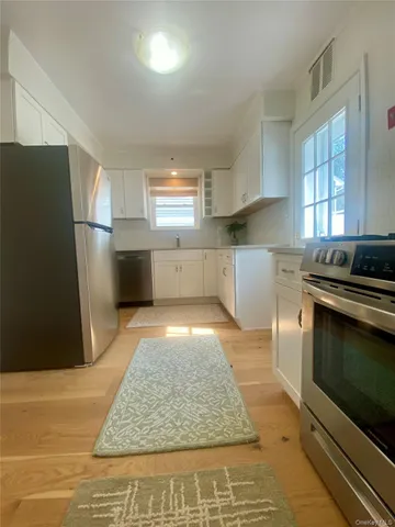 a kitchen with a sink stainless steel appliances and cabinets