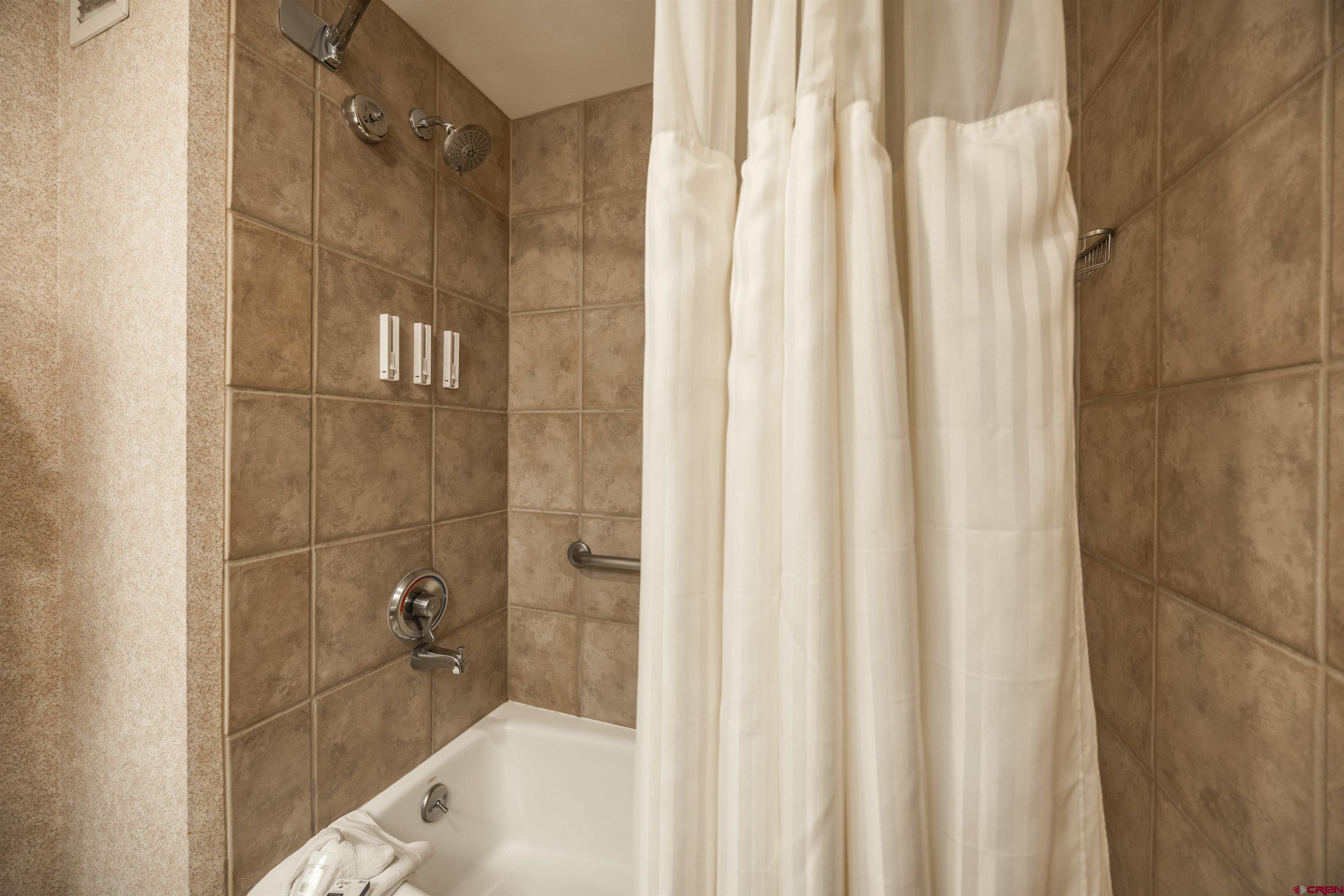 6 Emmons Road, Unit 553 Crested Butte, CO 81225 - Photo 12 of 27 a bathroom with a shower and a sink