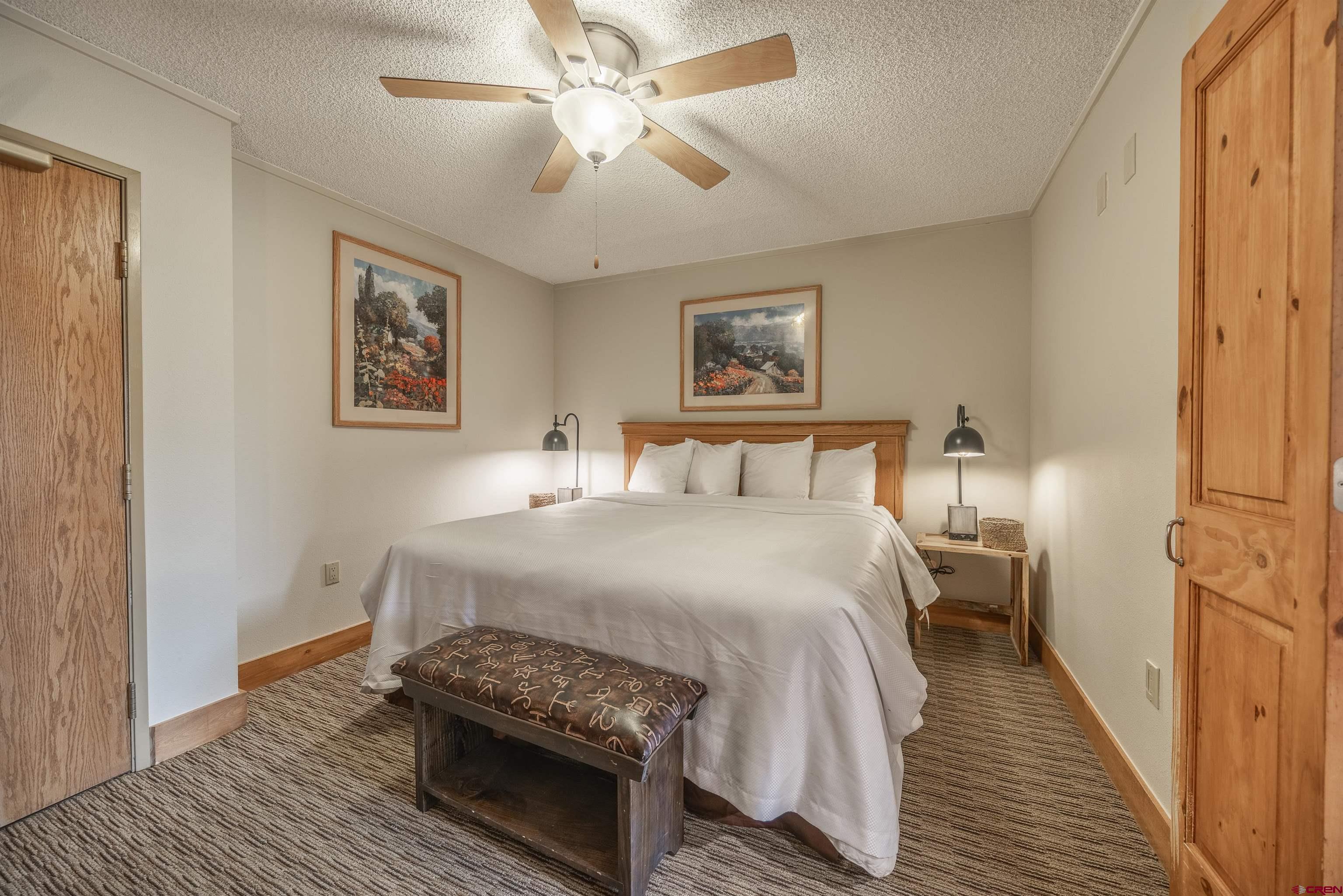 6 Emmons Road, Unit 553 Crested Butte, CO 81225 - Photo 2 of 27 a bedroom with a bed and a chandelier
