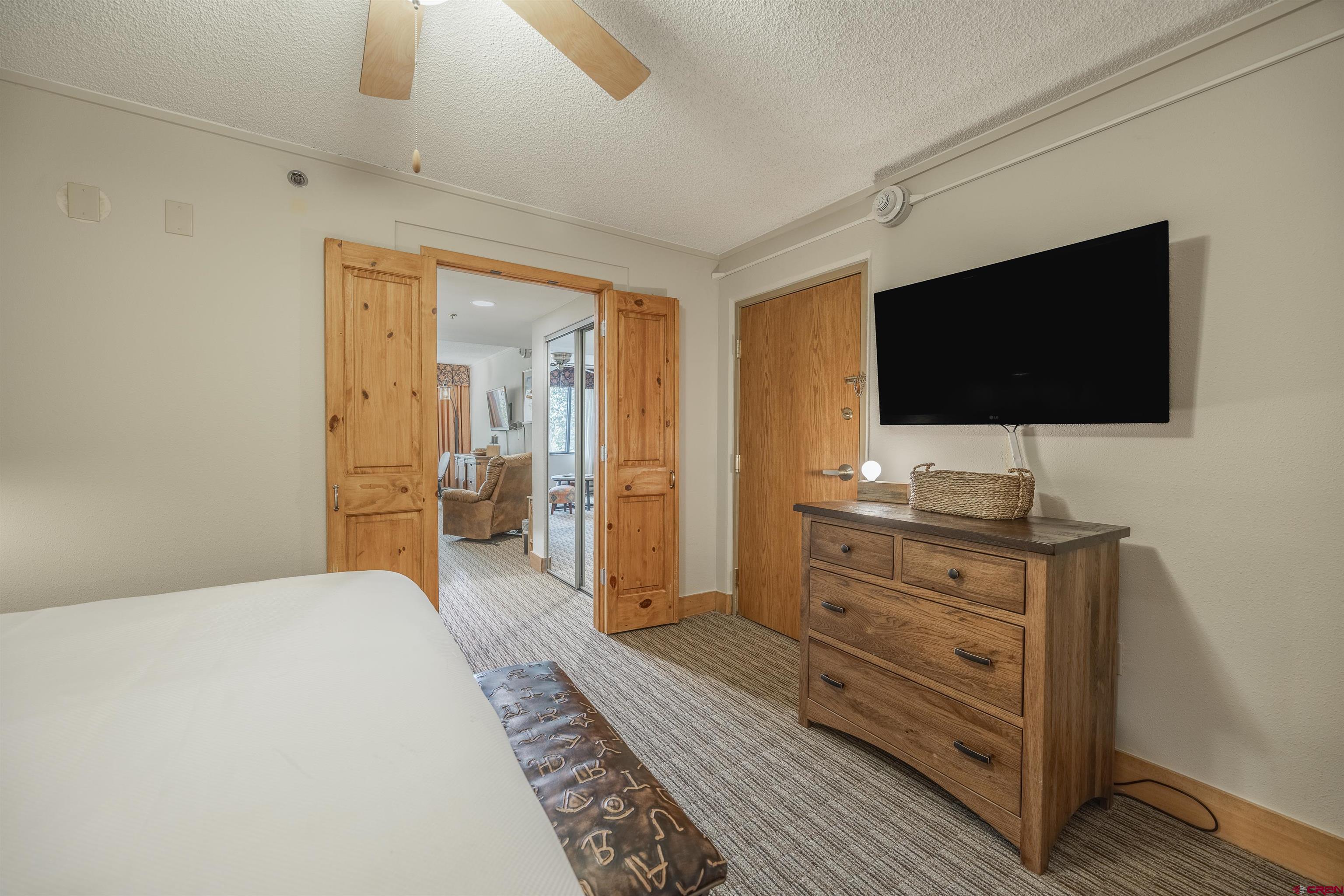 6 Emmons Road, Unit 553 Crested Butte, CO 81225 - Photo 4 of 27 a bedroom with a bed and a flat screen tv