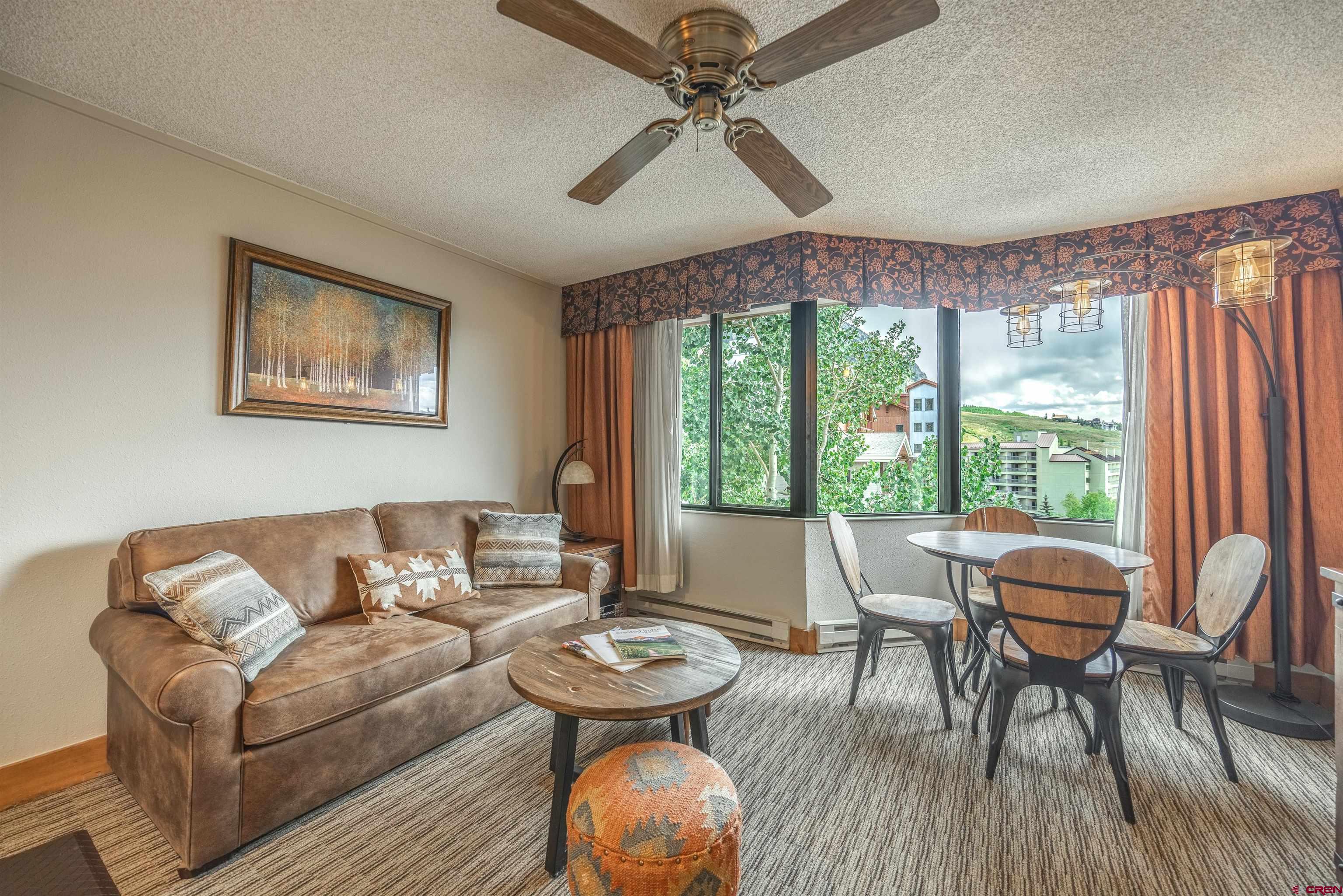 6 Emmons Road, Unit 553 Crested Butte, CO 81225 - Photo 5 of 27 a living room with furniture and a large window