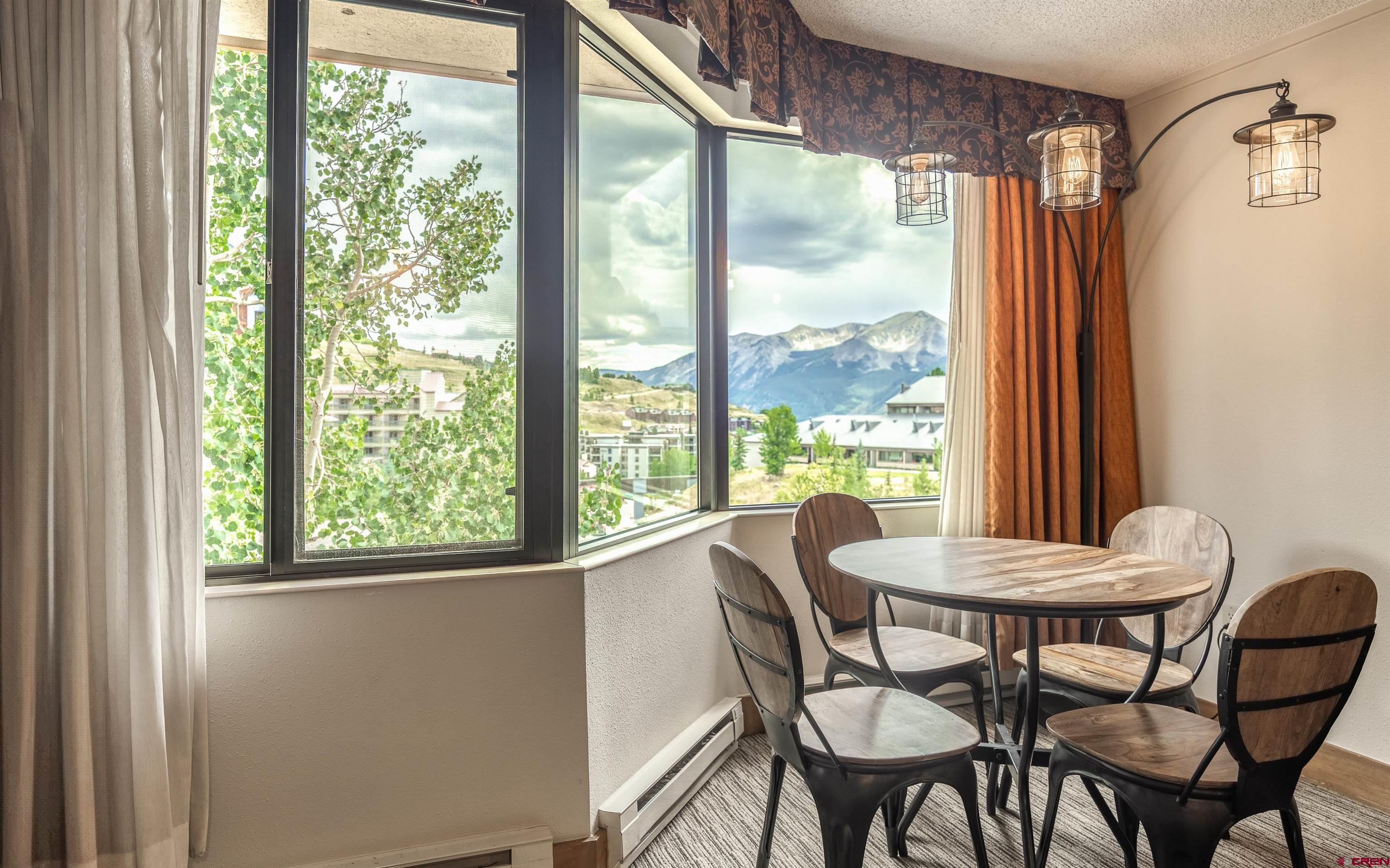 6 Emmons Road, Unit 553 Crested Butte, CO 81225 - Photo 8 of 27 a view of a dining room with furniture and a window