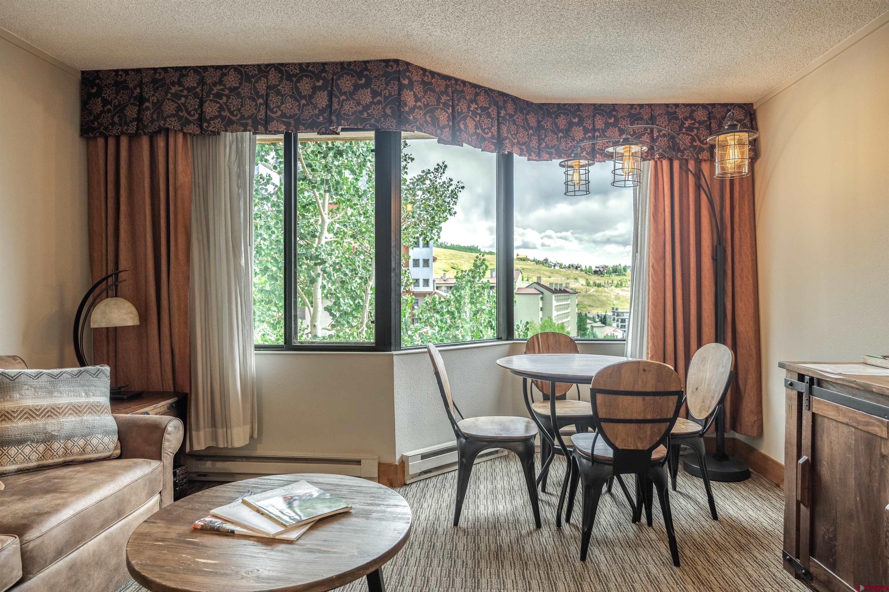 6 Emmons Road, Unit 553 Crested Butte, CO 81225 - Photo 9 of 27 a living room with furniture and a large window