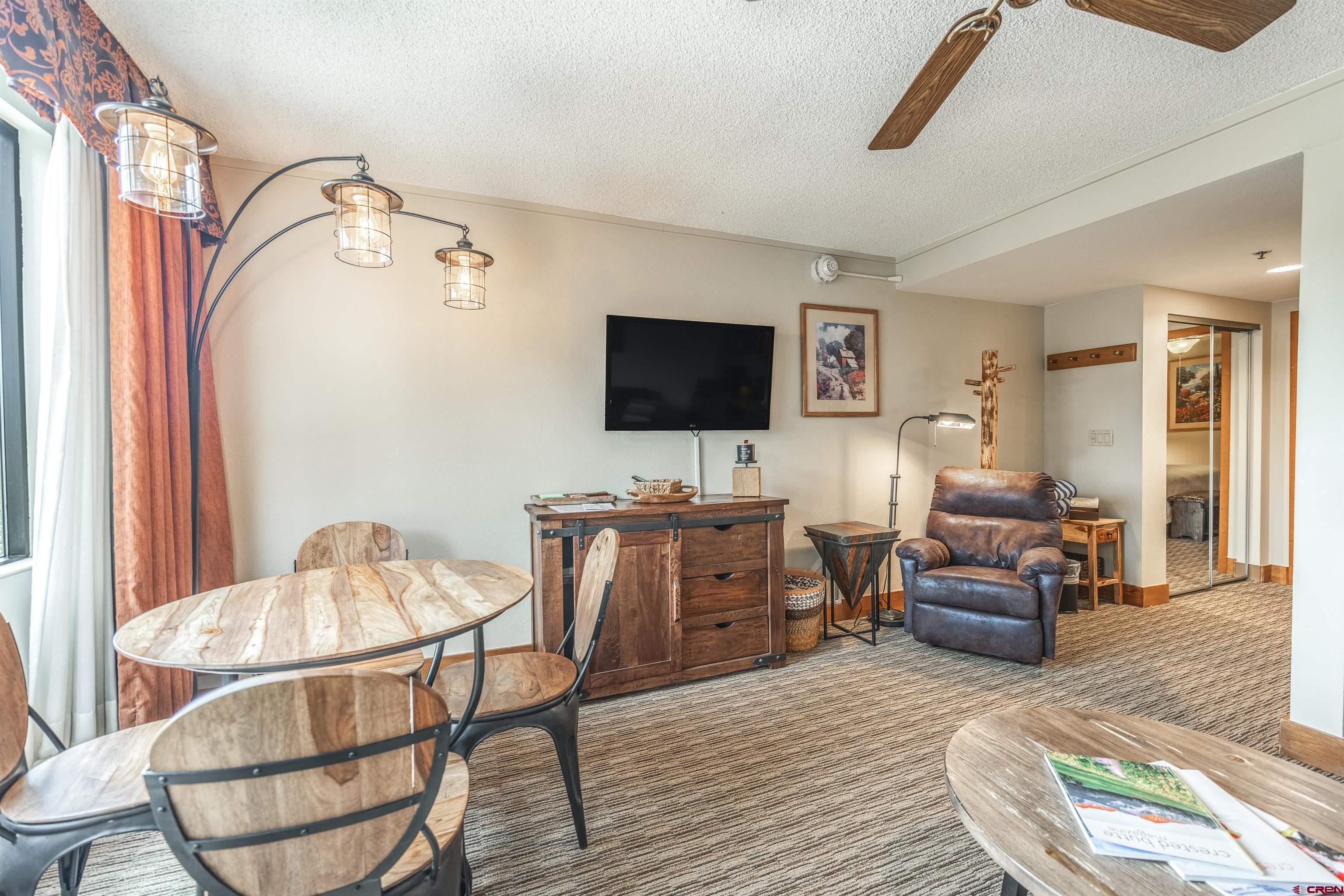 6 Emmons Road, Unit 553 Crested Butte, CO 81225 - Photo 10 of 27 a living room with furniture and a flat screen tv