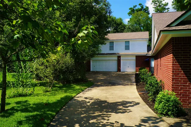 a front view of a house with a yard and a garage