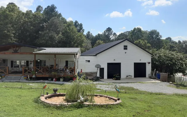 a view of a house with backyard and sitting area