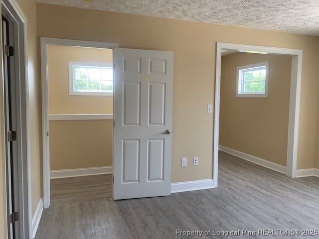 209 Godwin Street, Unit A Pembroke, NC 28372 - Photo 3 of 6 an empty room with wooden floor and windows