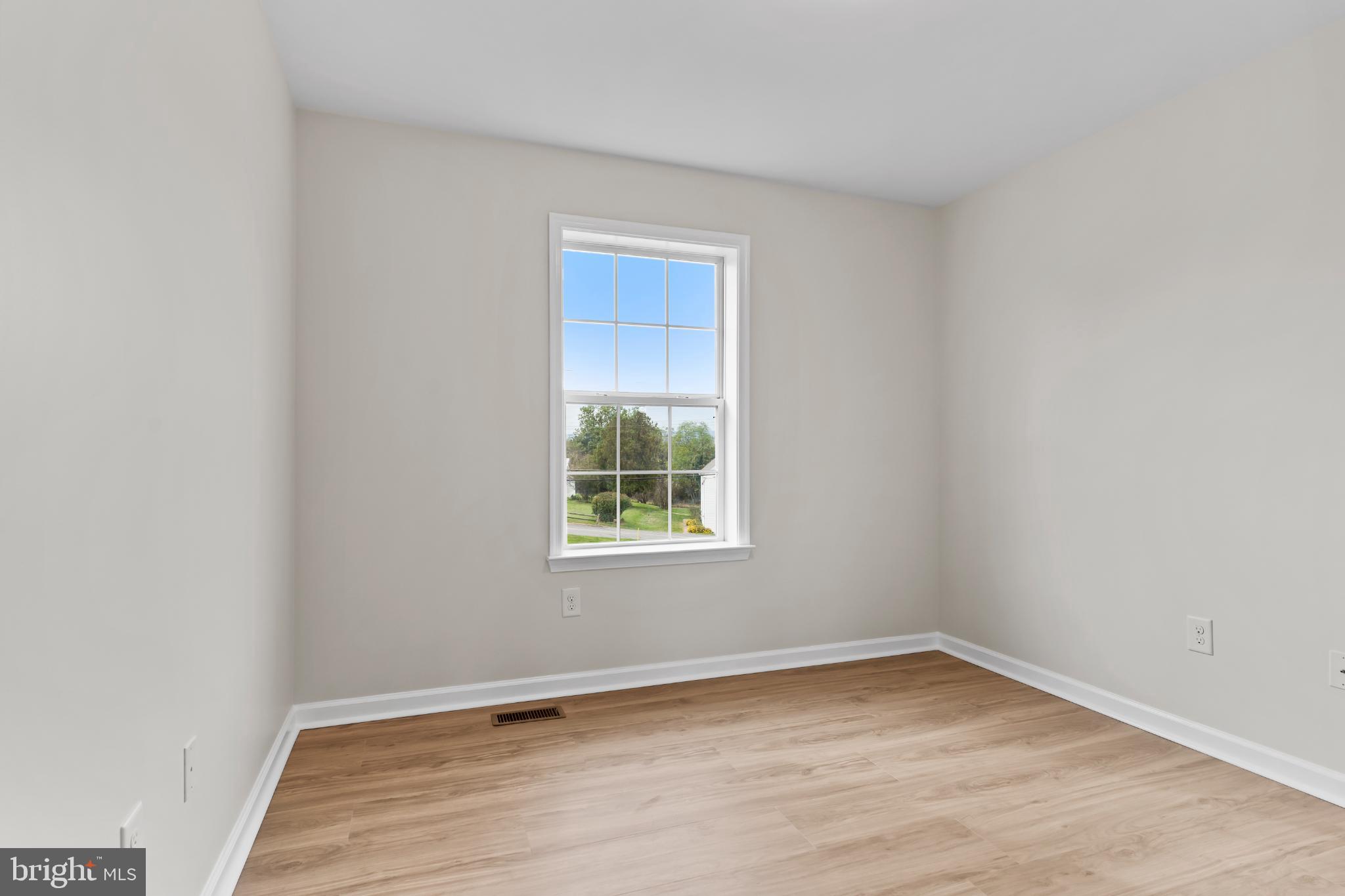 99 Middle Spring Road Shippensburg, PA 17257 - Photo 20 of 27 a view of an empty room with wooden floor and a window