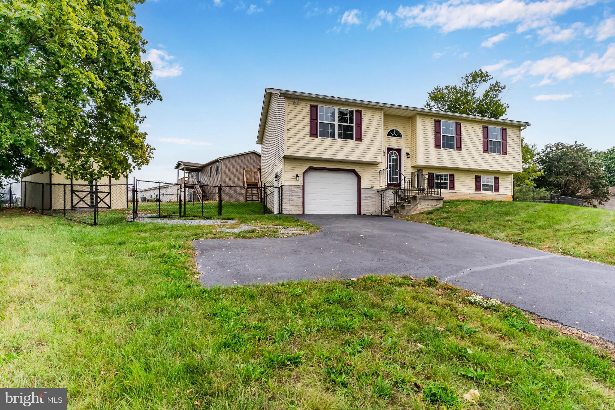 99 Middle Spring Road Shippensburg, PA 17257 - Photo 2 of 27 a front view of a house with a yard and garage
