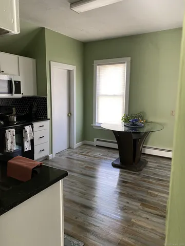 a kitchen with stainless steel appliances kitchen island a sink dishwasher a stove and a refrigerator