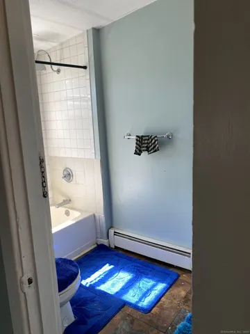 a bathroom with a bathtub and shower