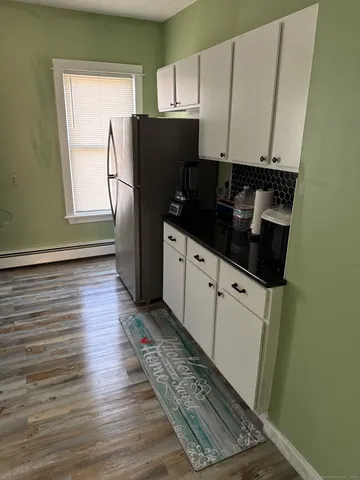 a kitchen with stainless steel appliances a refrigerator sink and cabinets