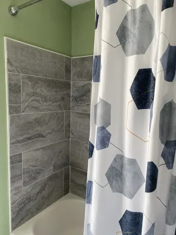 a bathroom with a toilet and a shower