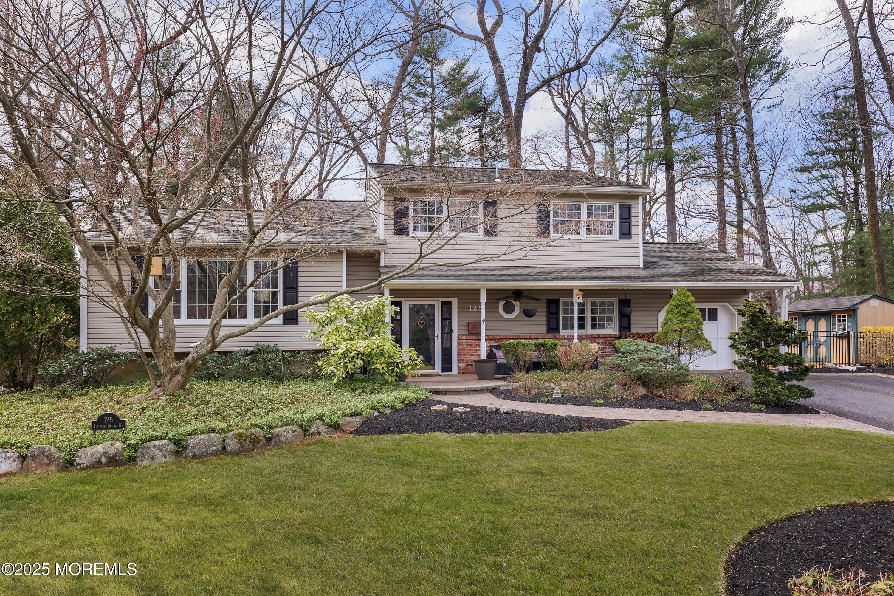 125 Jumping Brook Road Lincroft, NJ 07738 - Photo 11 of 47 a front view of a house with garden