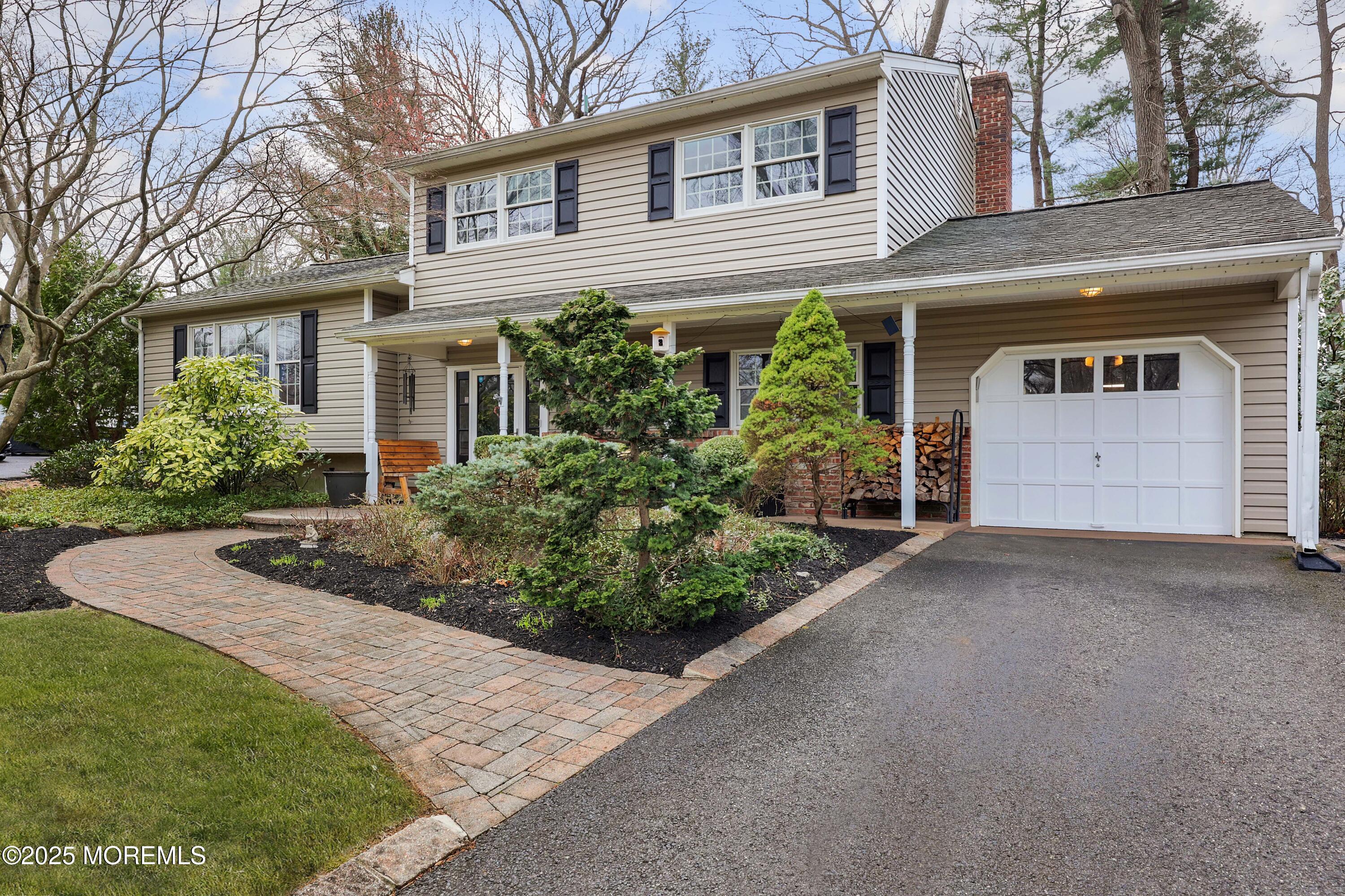 125 Jumping Brook Road Lincroft, NJ 07738 - Photo 13 of 47 front view of a house with a yard