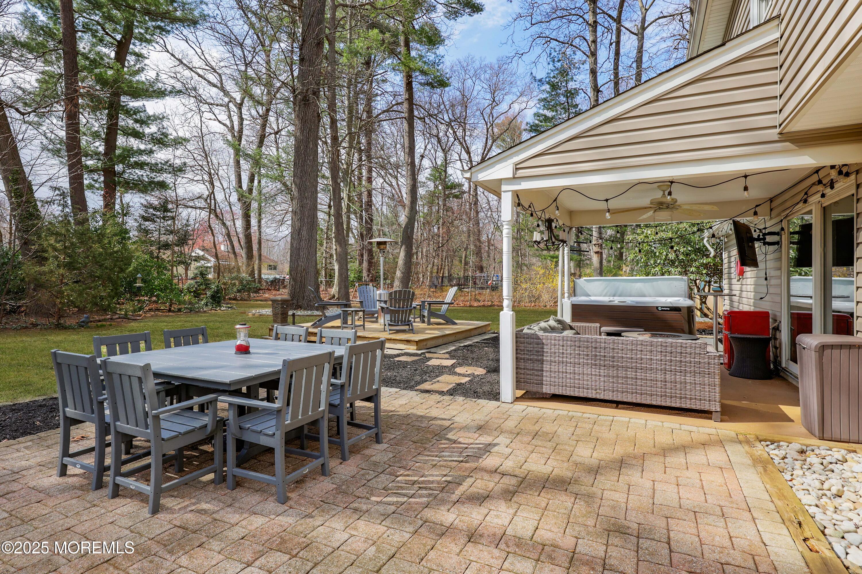 125 Jumping Brook Road Lincroft, NJ 07738 - Photo 15 of 47 a view of a dinning table and chairs in the patio