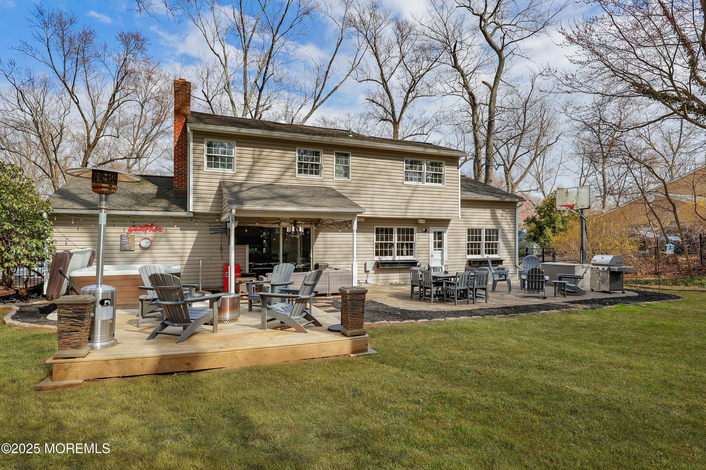 125 Jumping Brook Road Lincroft, NJ 07738 - Photo 19 of 47 a view of a house with sitting area and garden