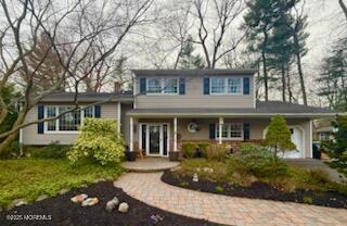 125 Jumping Brook Road Lincroft, NJ 07738 - Photo 2 of 47 front view of a house with a yard