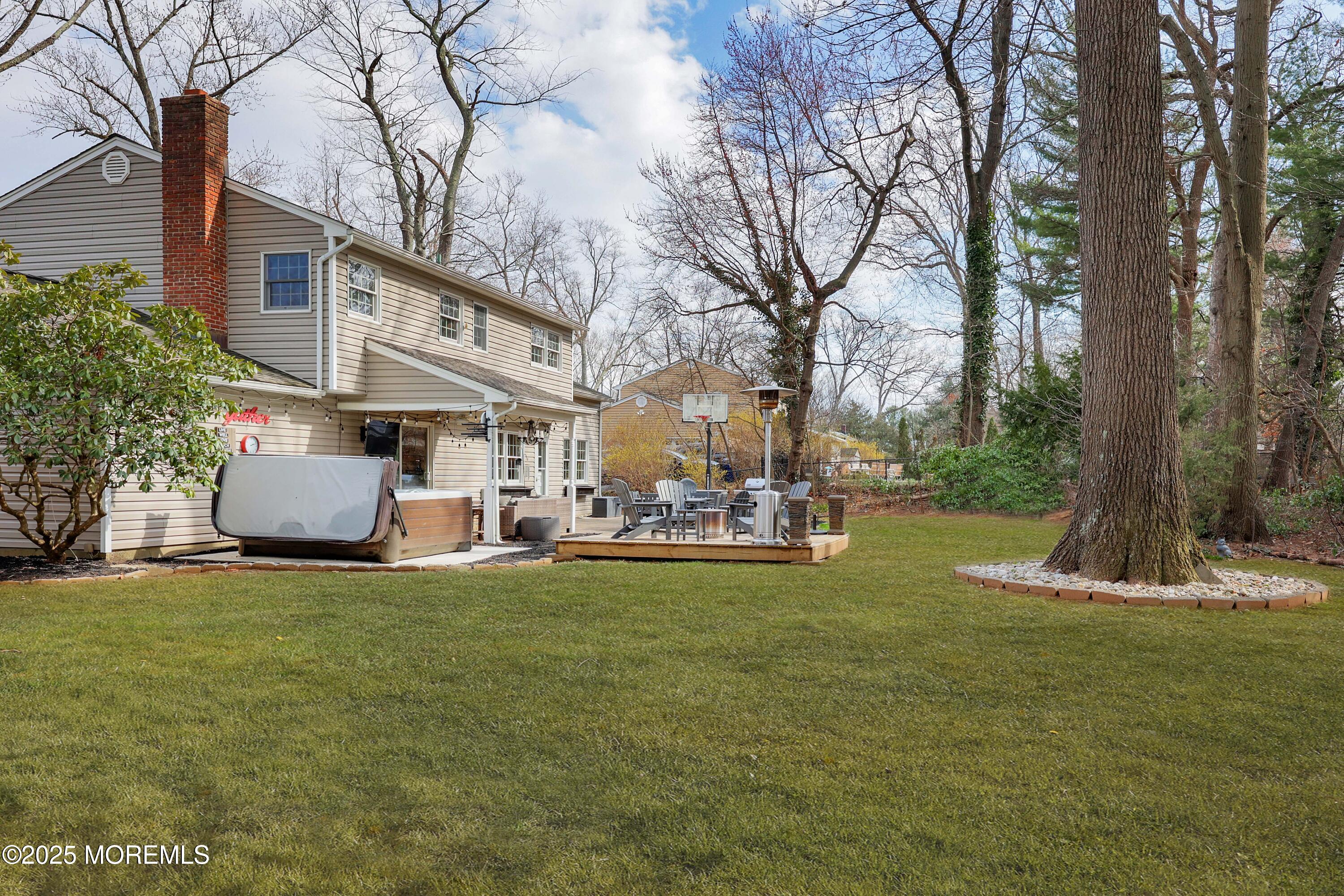 125 Jumping Brook Road Lincroft, NJ 07738 - Photo 21 of 47 a view of a house with a yard