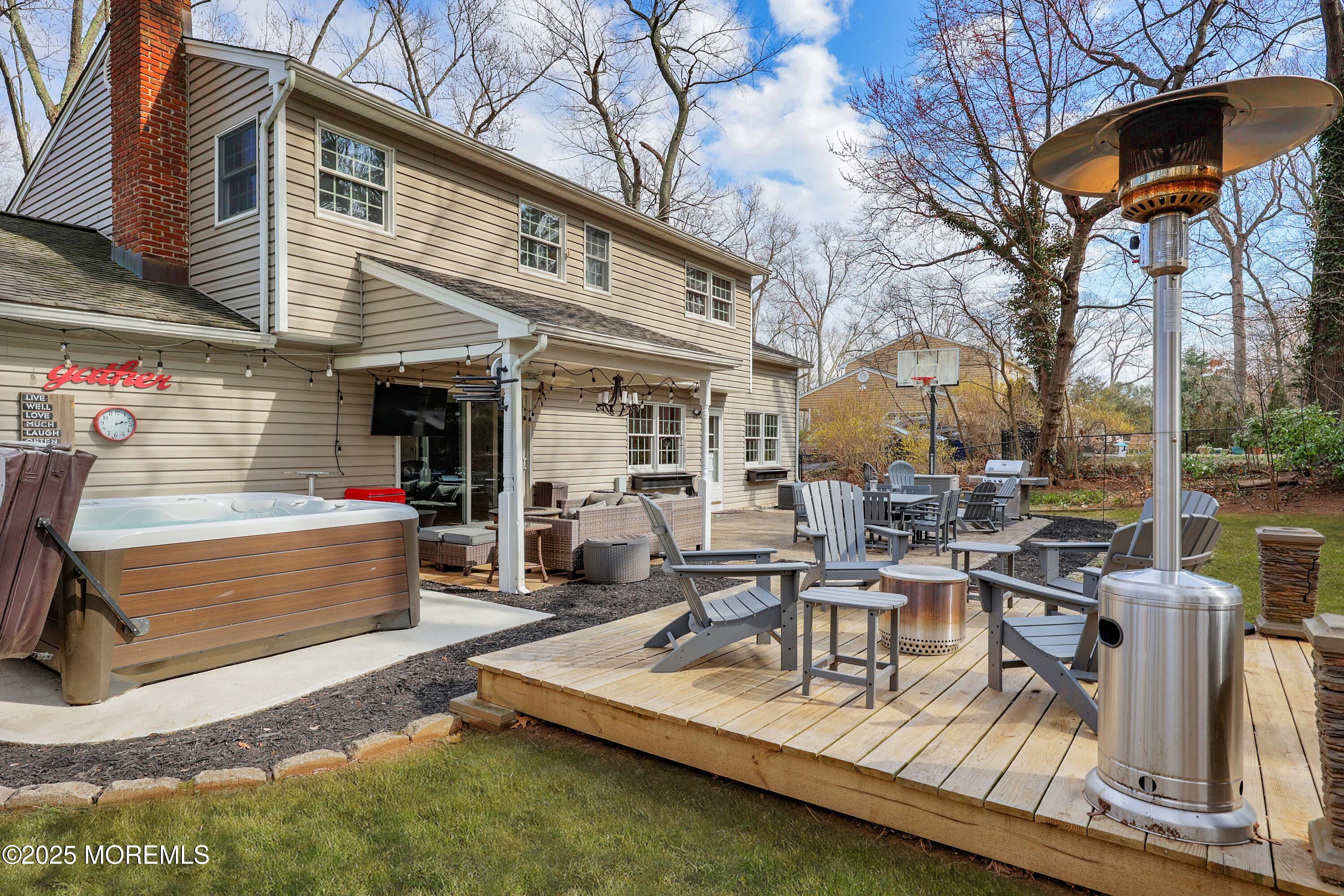 125 Jumping Brook Road Lincroft, NJ 07738 - Photo 22 of 47 a view of a patio with couches chairs and a barbeque
