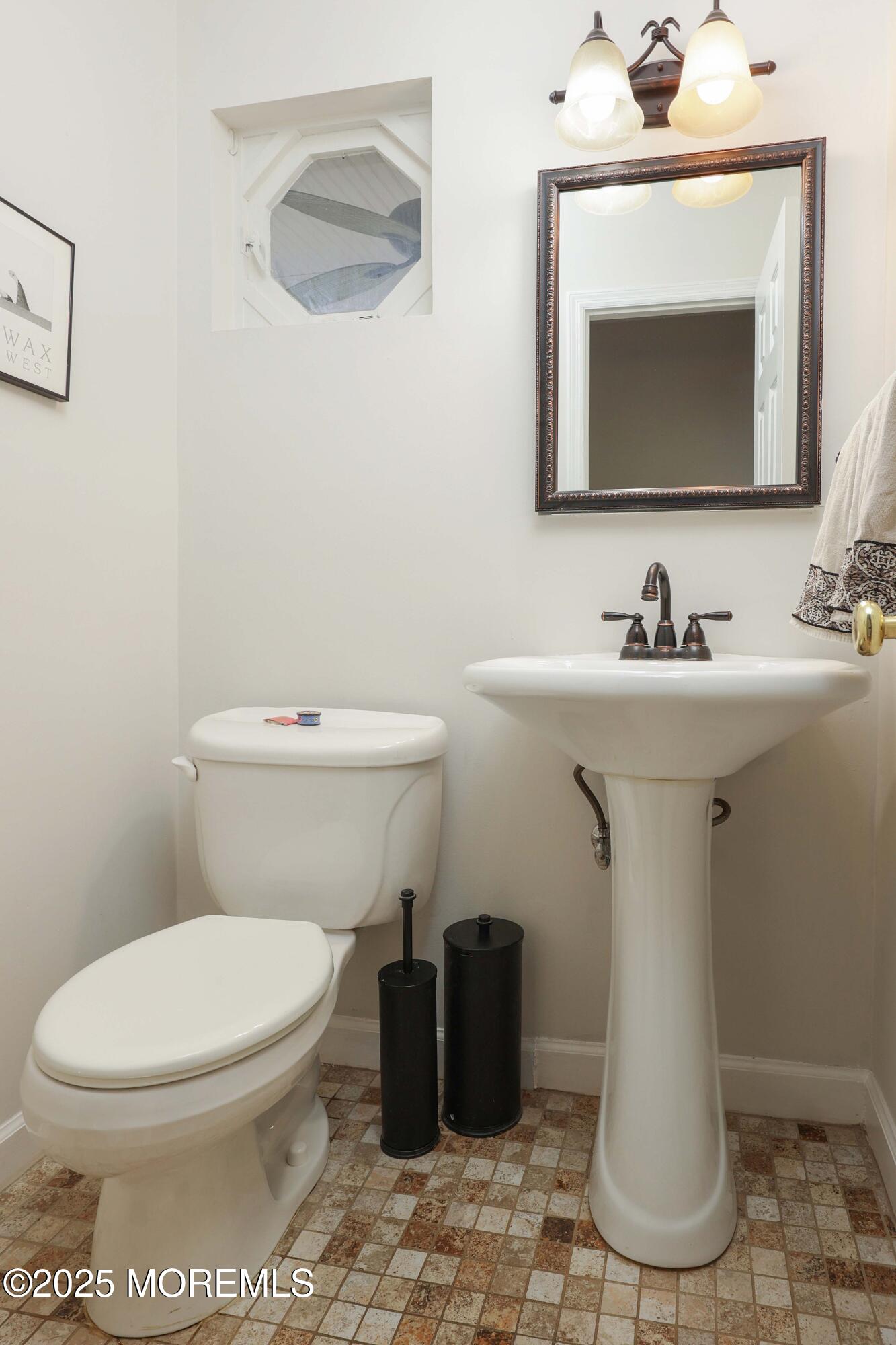 125 Jumping Brook Road Lincroft, NJ 07738 - Photo 26 of 47 a bathroom with a toilet sink and mirror