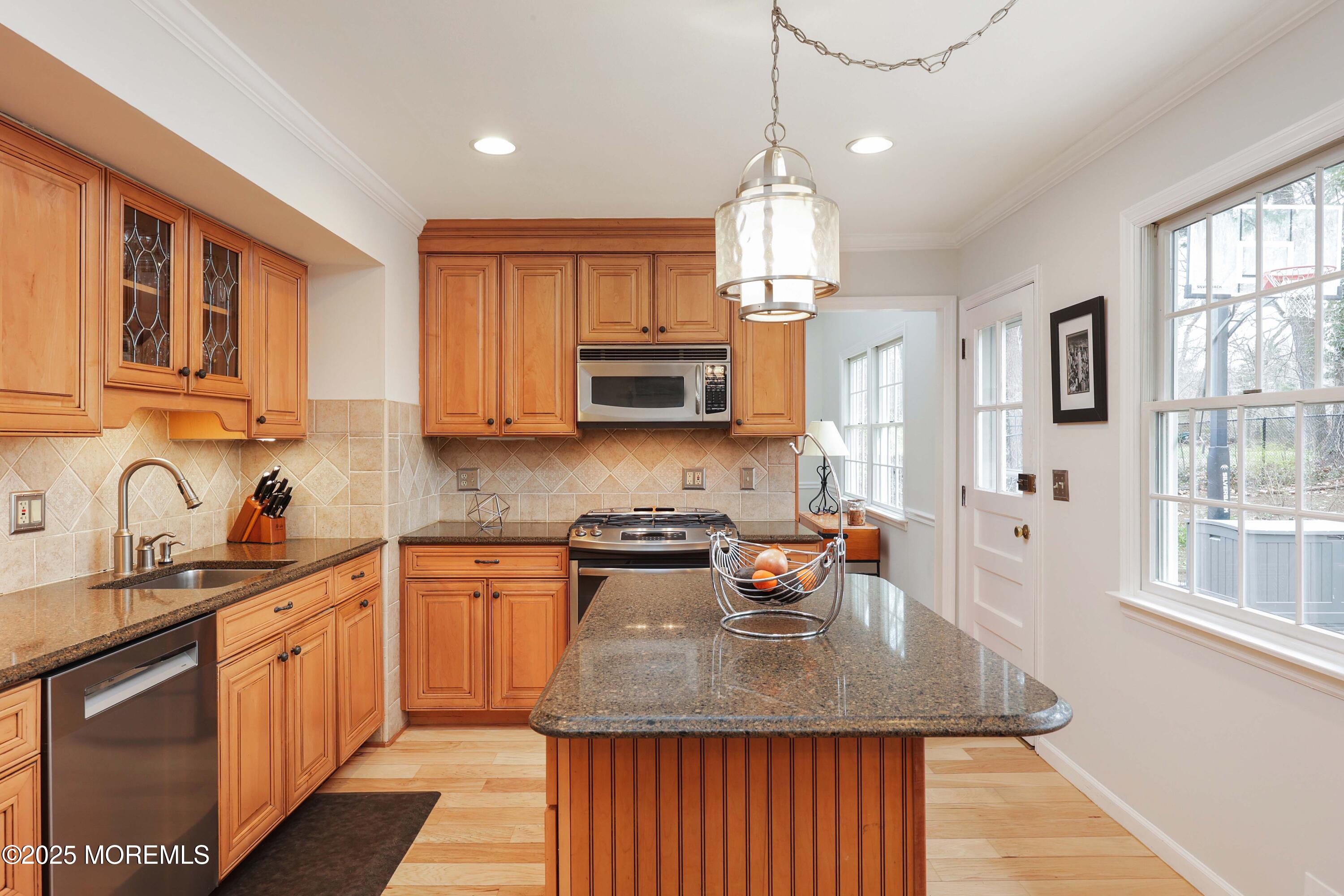 125 Jumping Brook Road Lincroft, NJ 07738 - Photo 30 of 47 a kitchen with stainless steel appliances granite countertop a sink stove and refrigerator