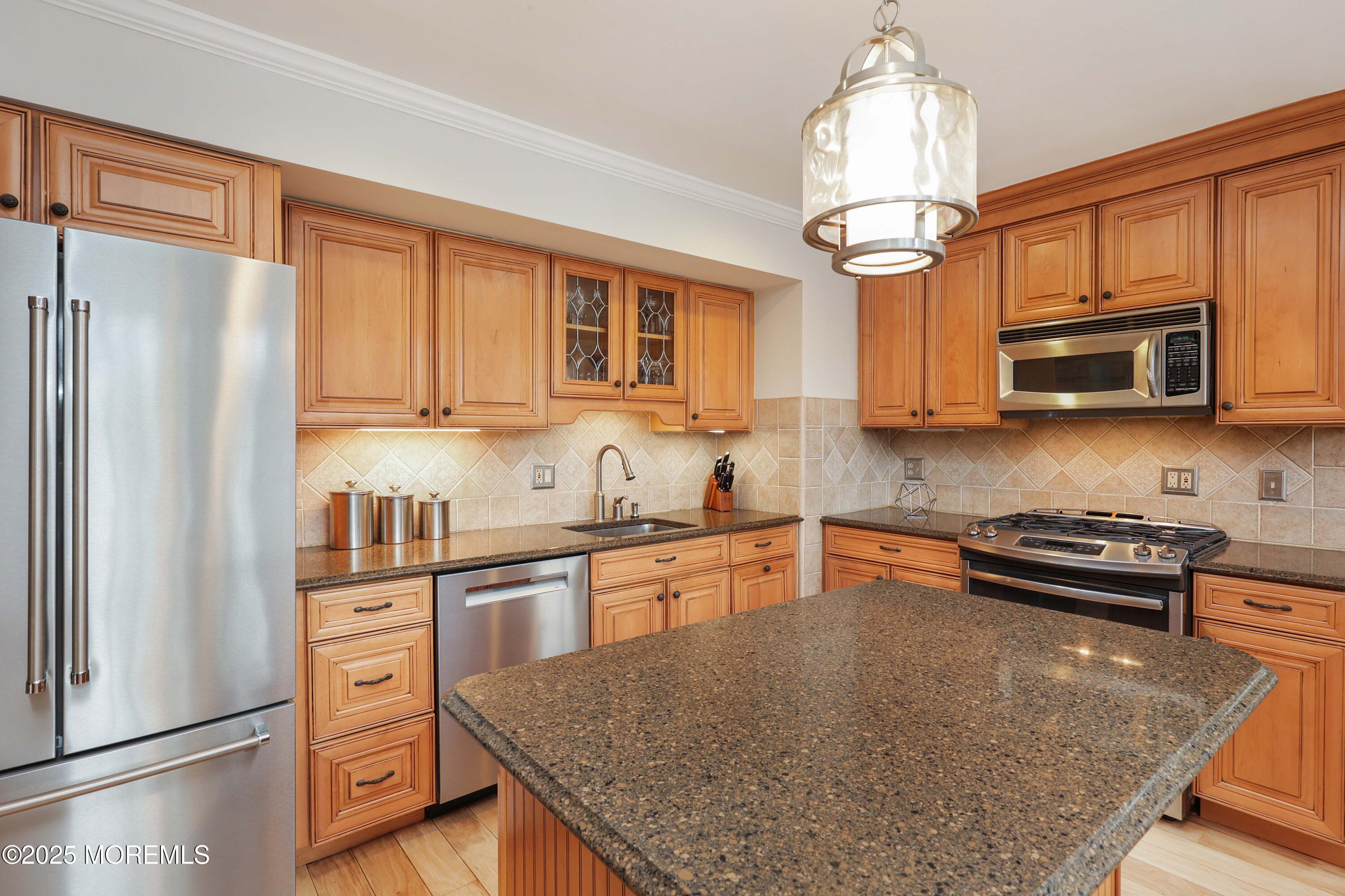 125 Jumping Brook Road Lincroft, NJ 07738 - Photo 31 of 47 a kitchen with stainless steel appliances granite countertop a refrigerator a stove top oven a sink and dishwasher