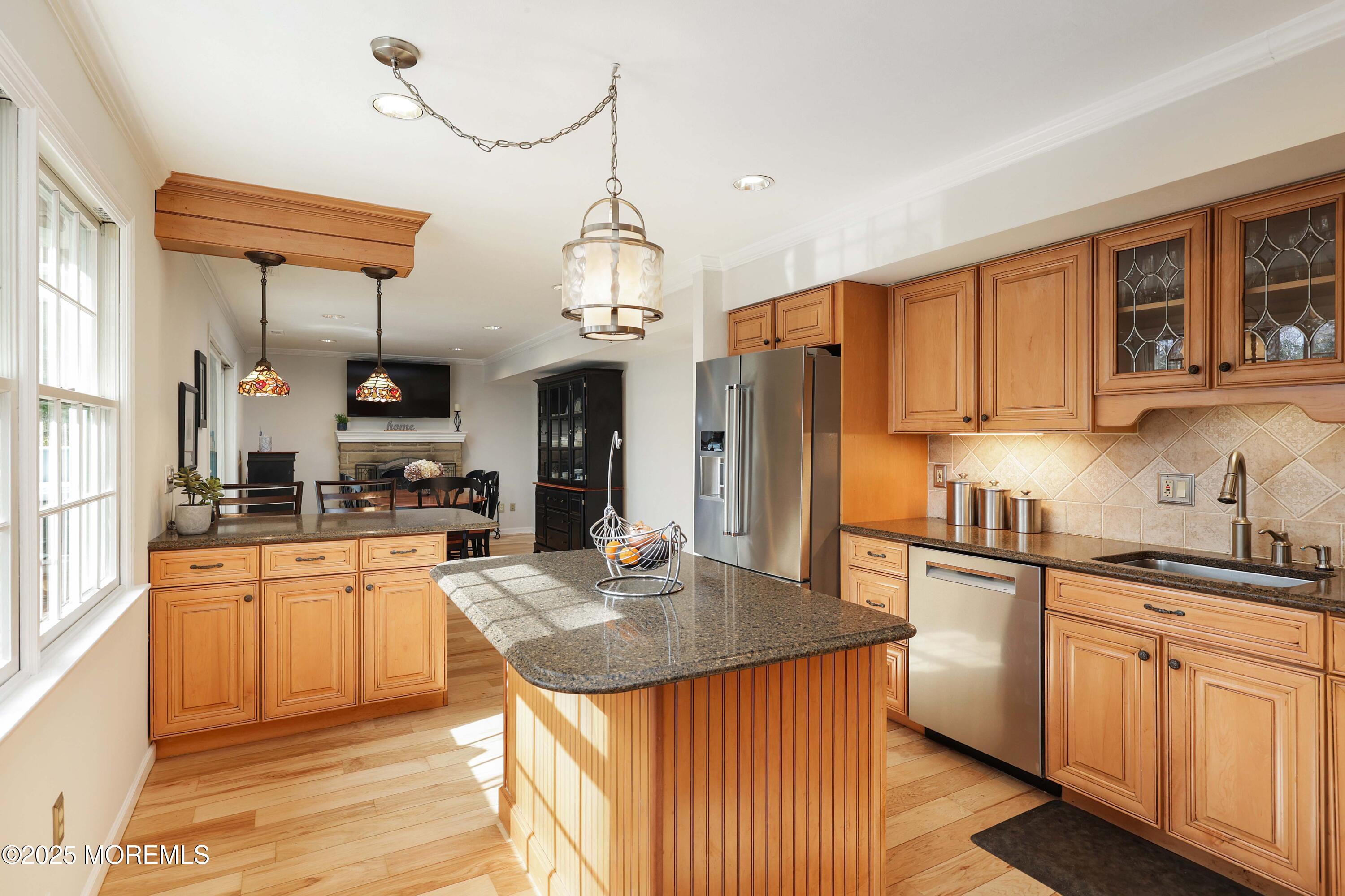 125 Jumping Brook Road Lincroft, NJ 07738 - Photo 33 of 47 a kitchen with stainless steel appliances granite countertop a sink a stove a refrigerator cabinets and living room view