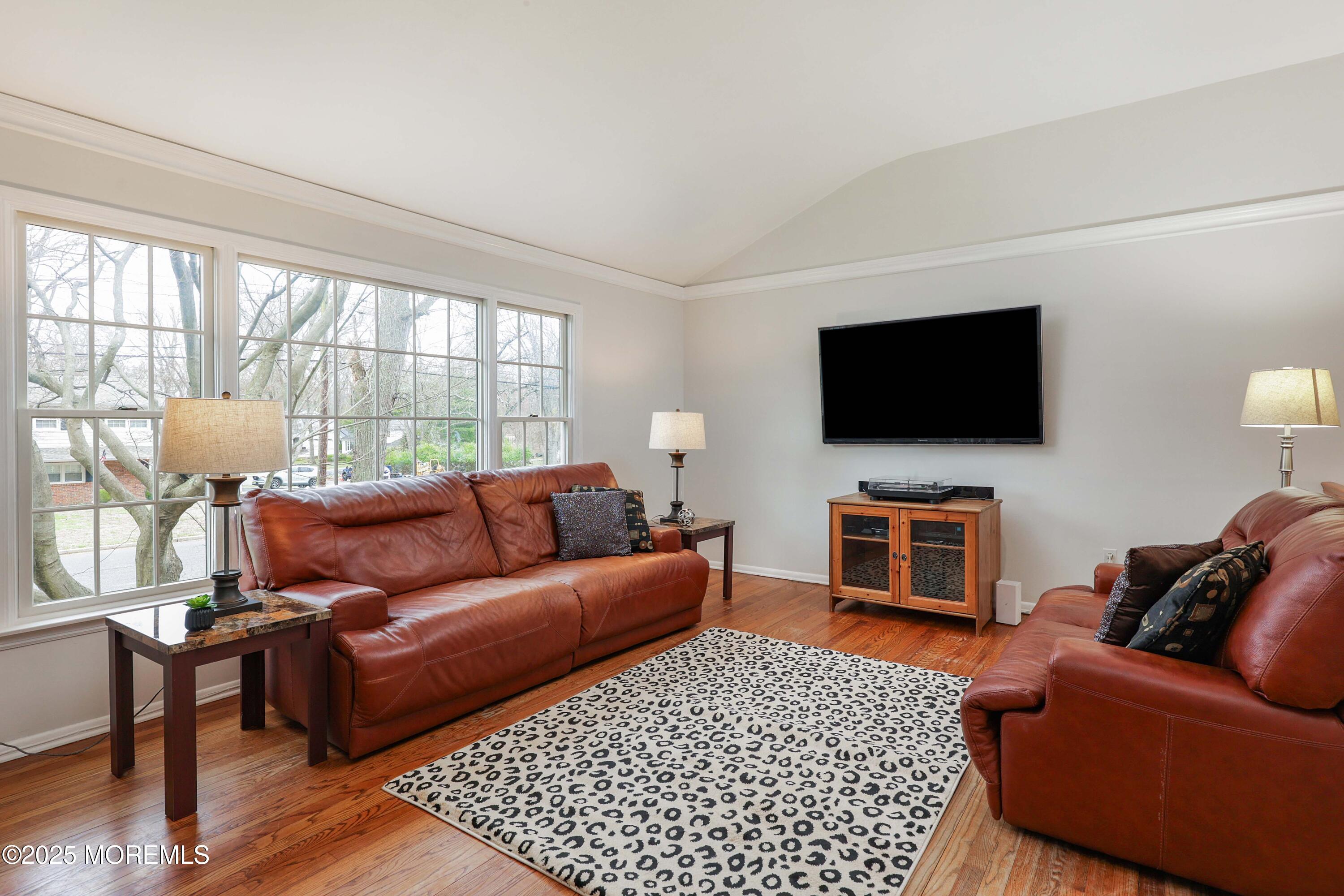 125 Jumping Brook Road Lincroft, NJ 07738 - Photo 38 of 47 a living room with furniture and a flat screen tv