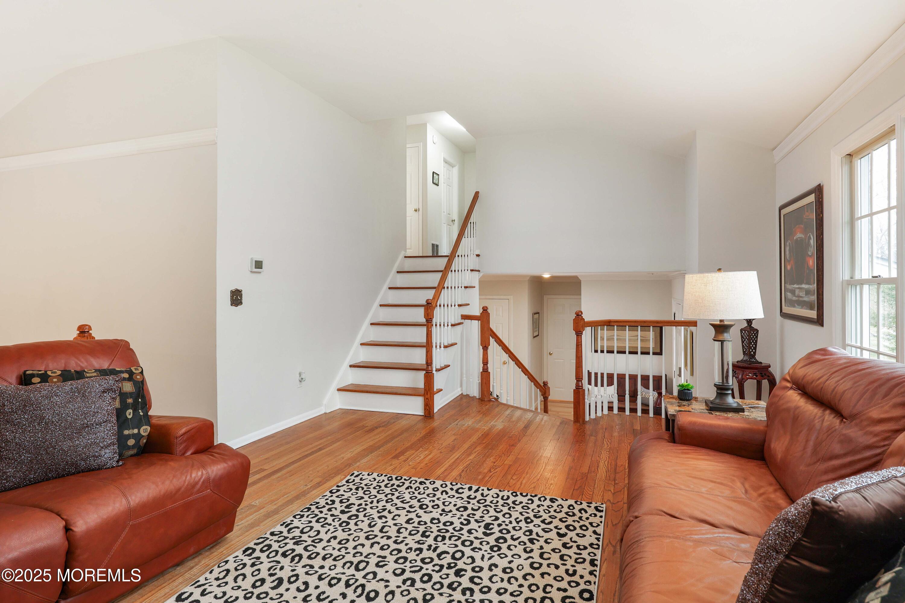 125 Jumping Brook Road Lincroft, NJ 07738 - Photo 39 of 47 a living room with furniture and a wooden floor