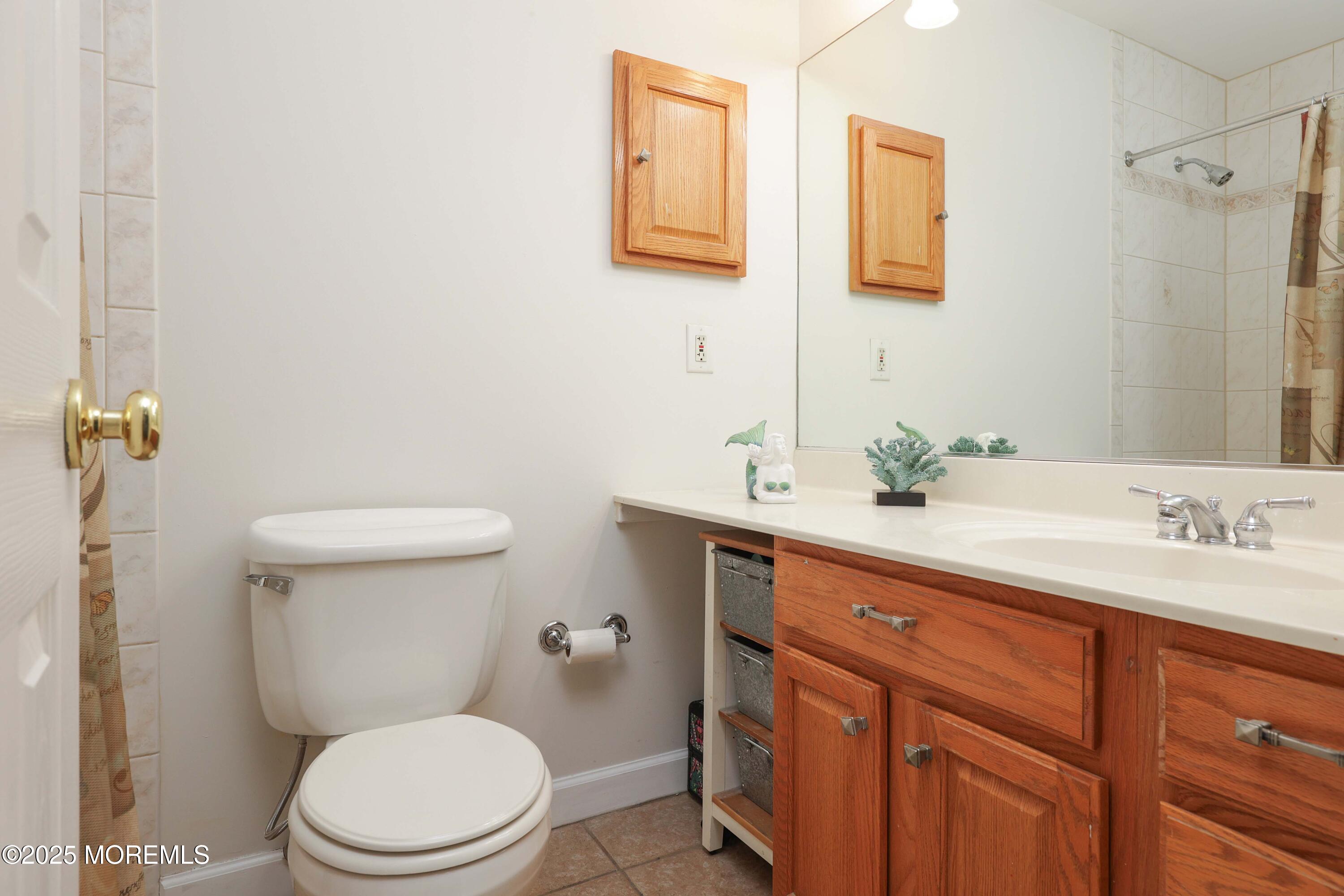 125 Jumping Brook Road Lincroft, NJ 07738 - Photo 41 of 47 a bathroom with a toilet a sink a mirror and vanity