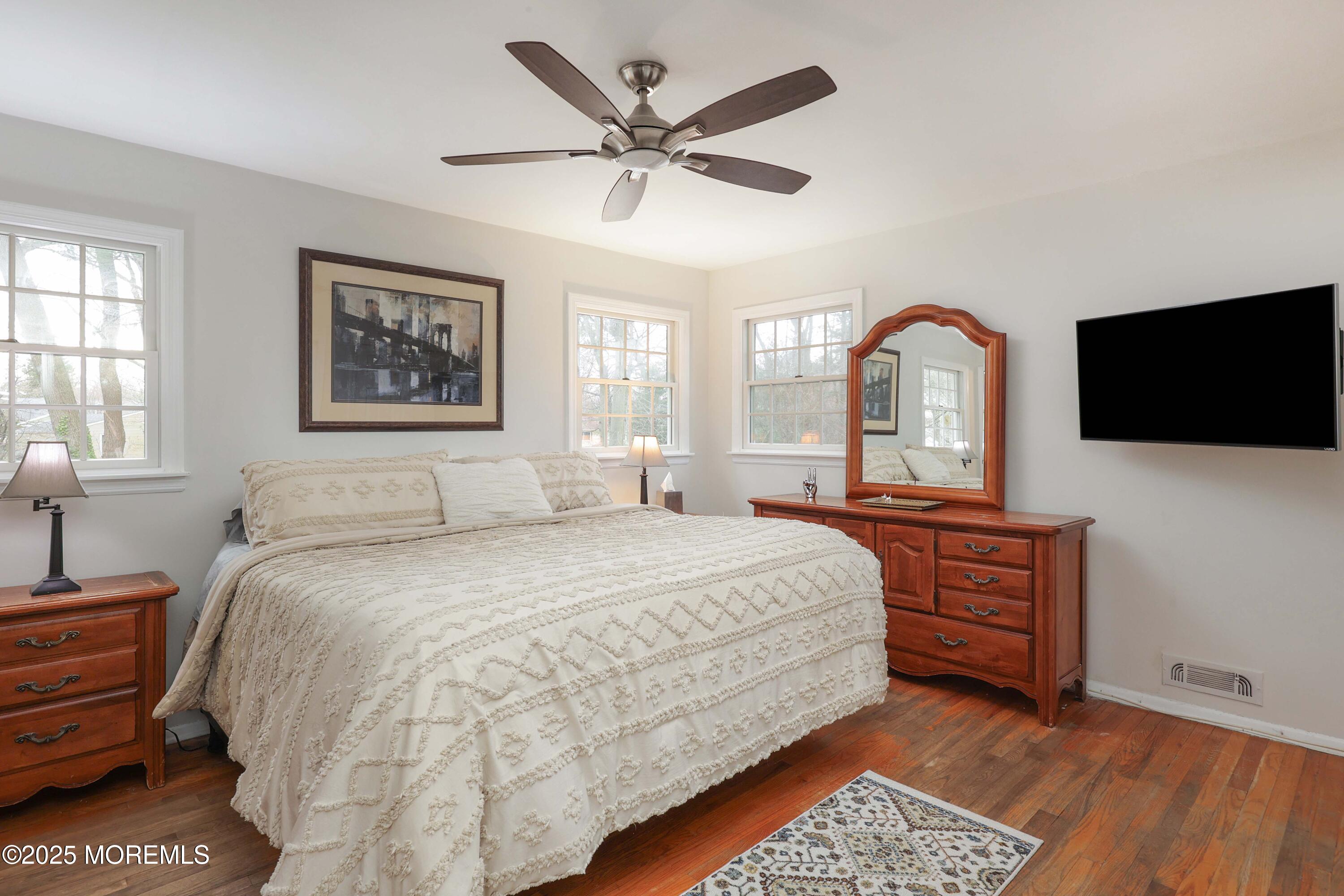 125 Jumping Brook Road Lincroft, NJ 07738 - Photo 43 of 47 a spacious bedroom with a bed and a flat screen tv