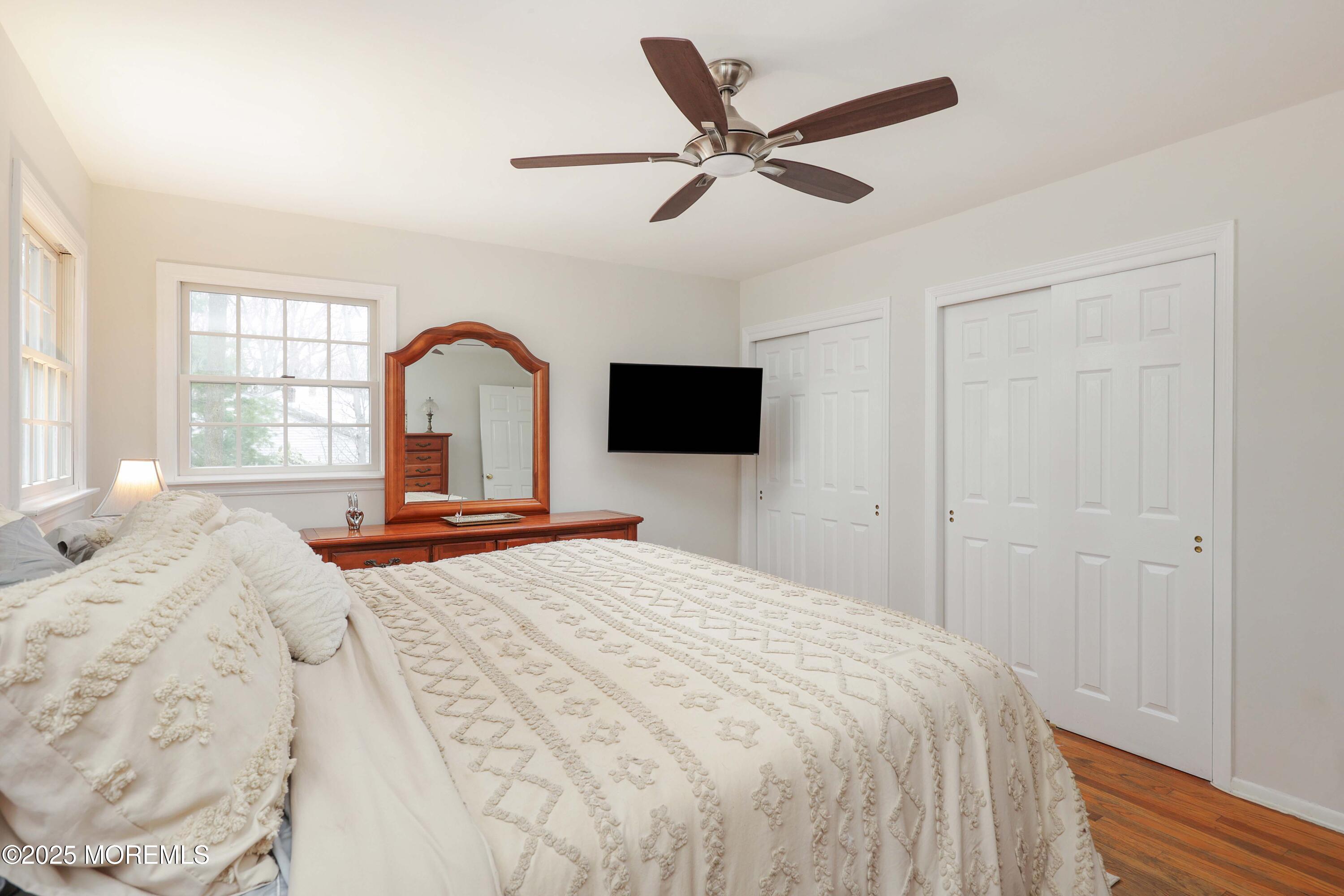 125 Jumping Brook Road Lincroft, NJ 07738 - Photo 44 of 47 a bedroom with a bed and a flat screen tv