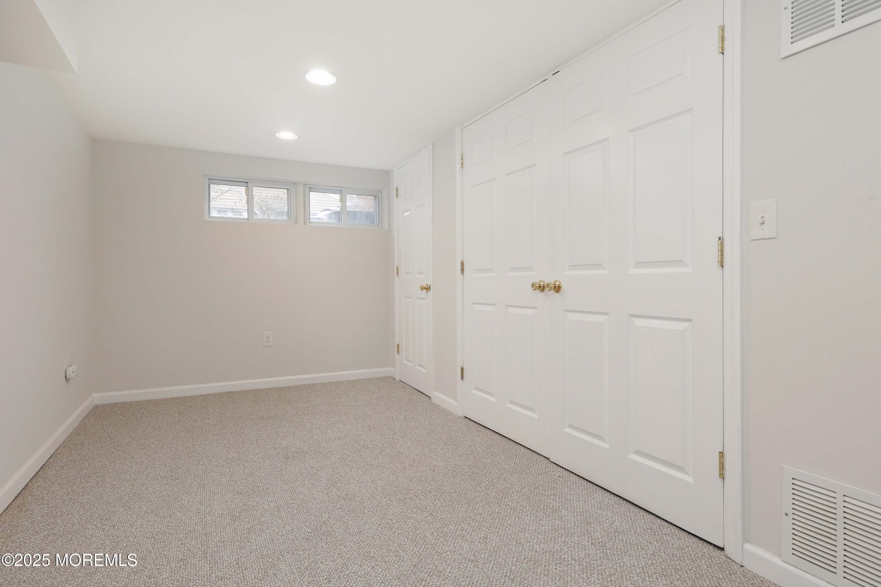 125 Jumping Brook Road Lincroft, NJ 07738 - Photo 47 of 47 an empty room with windows and closet